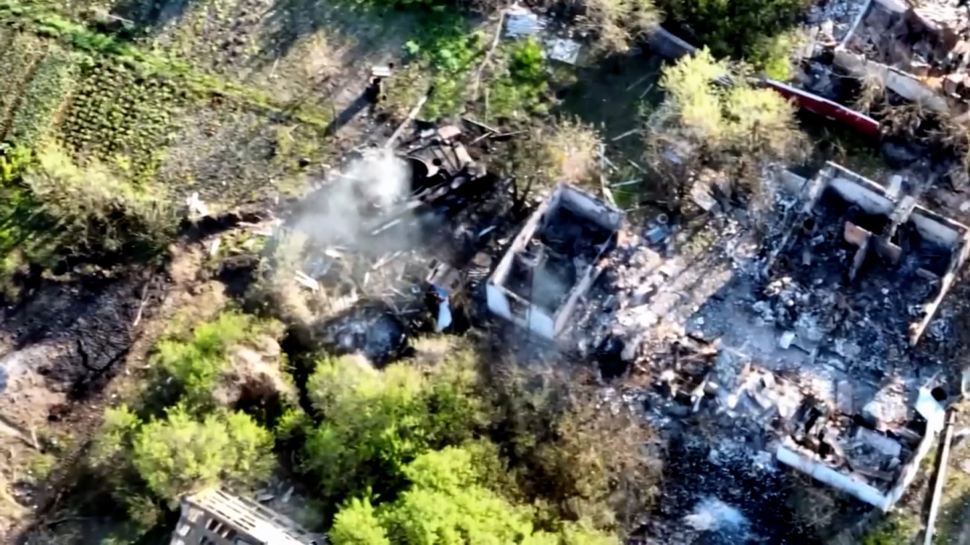 A drone video shows a smoldering Russian military vehicle in Oleksandrivka, Ukraine. 