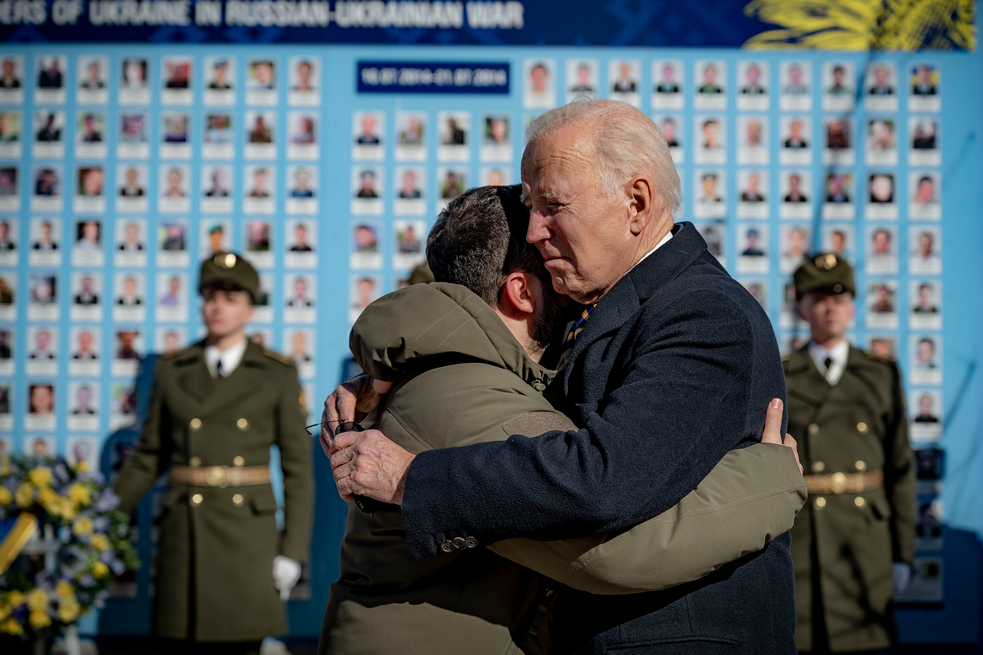 President Joe Biden, right, and Ukrainian President Volodymyr Zelensky hug as they say goodbye at the Memorial Wall of Fallen Defenders of Ukraine in Russian-Ukrainian War with photos of killed soldiers, in Kyiv on Monday, February 20. 