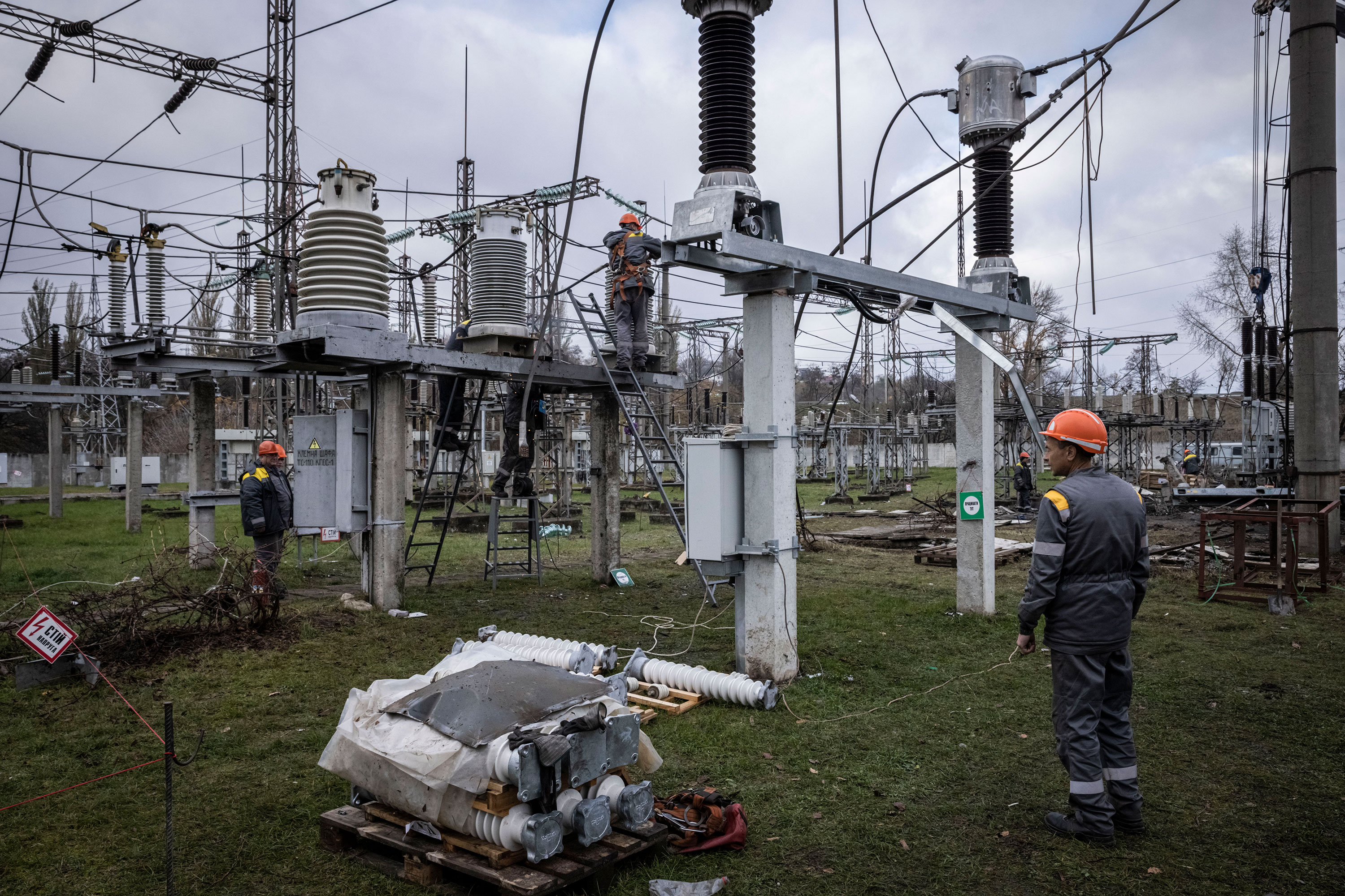 Workers repair infrastructure at a power station that was damaged by a Russian air attack November 4, 2022, in Kyiv Oblast. 