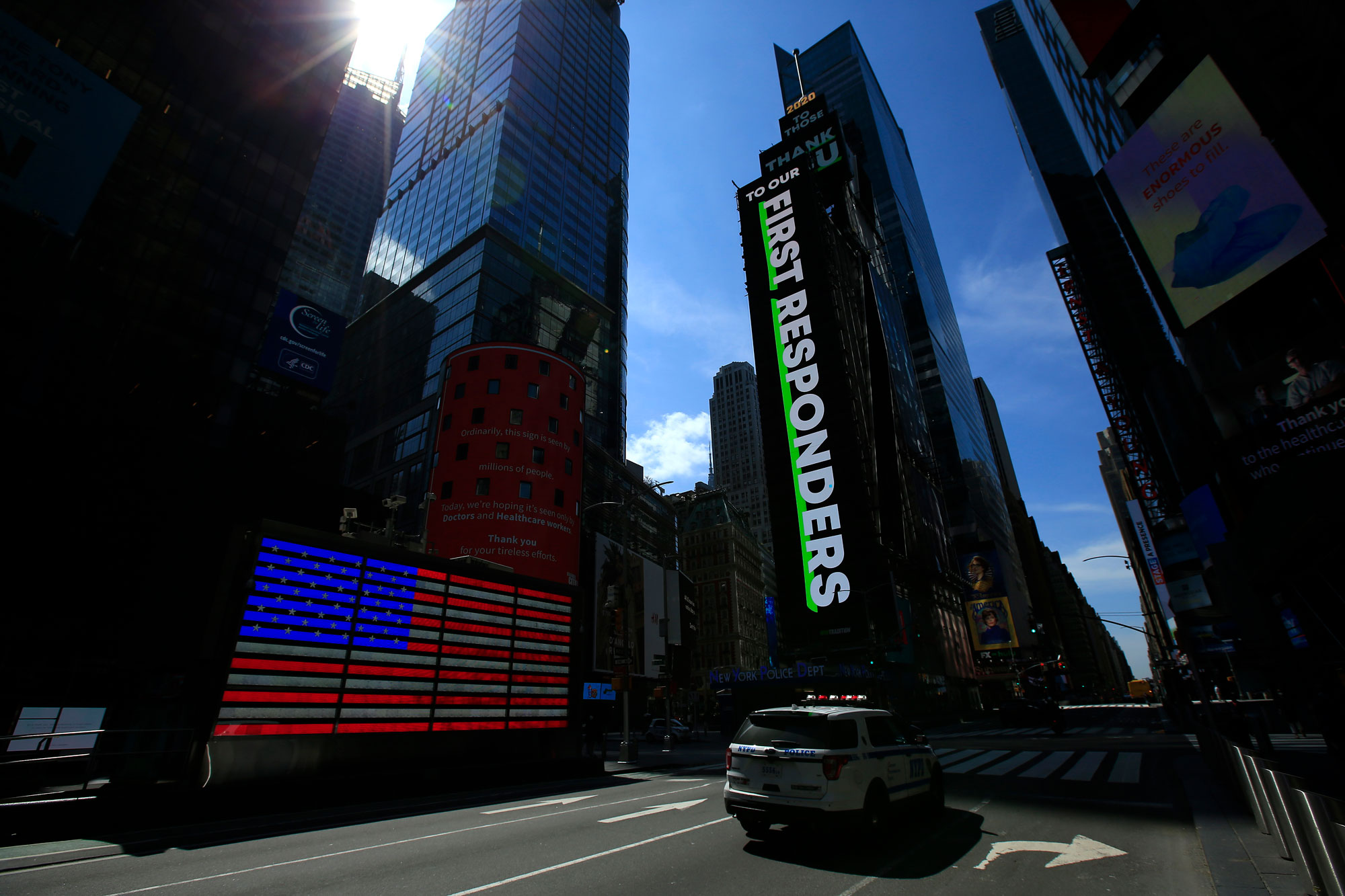 A NYPD vehicle passes through a nearly empty Times Square during the coronavirus pandemic on April 25 in New York City. 