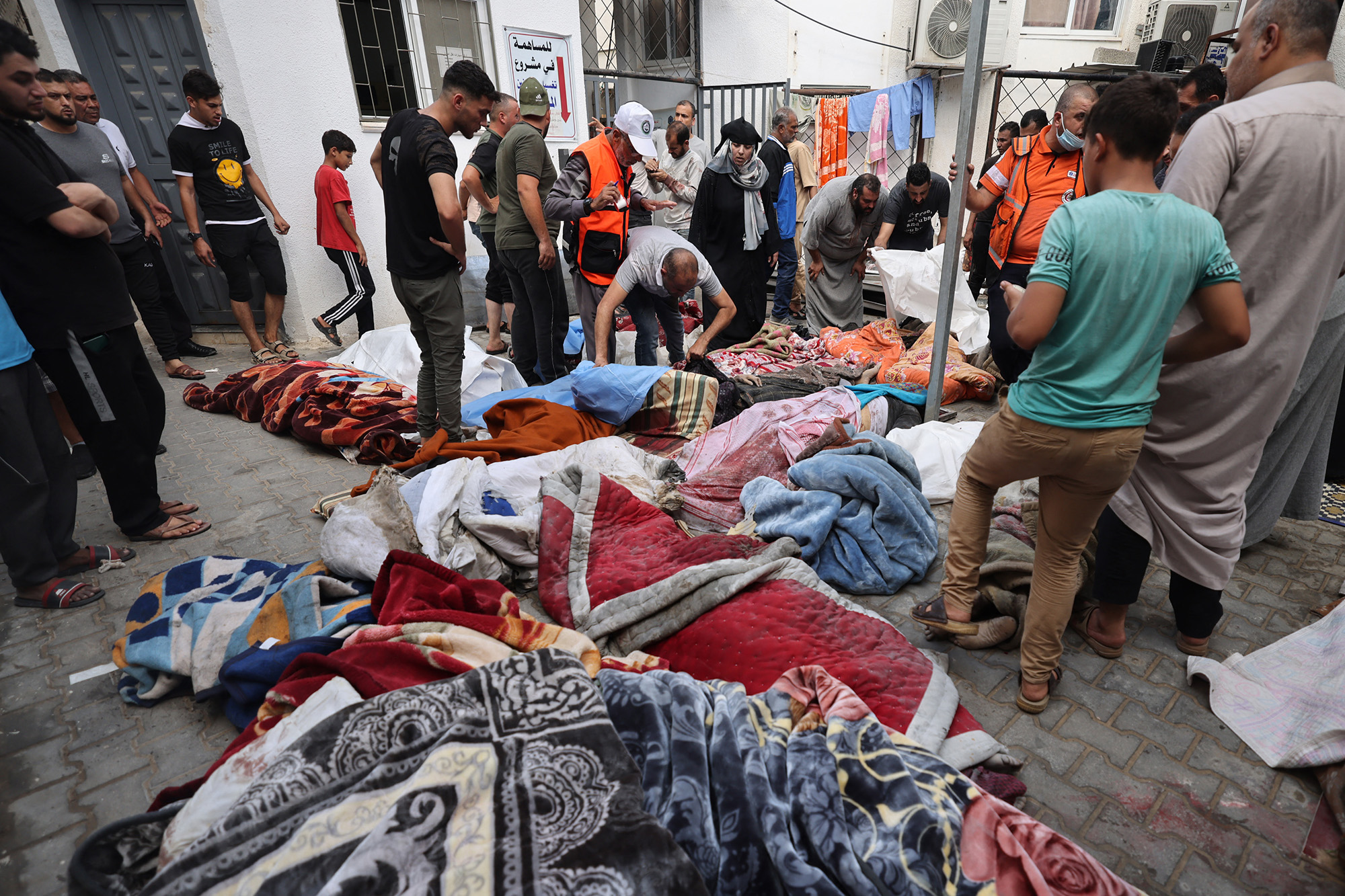 Palestinians victims covered in blankets are laid out on the ground at a hospital following an Israeli airstrike on Rafah, in southern Gaza, on October 17.
