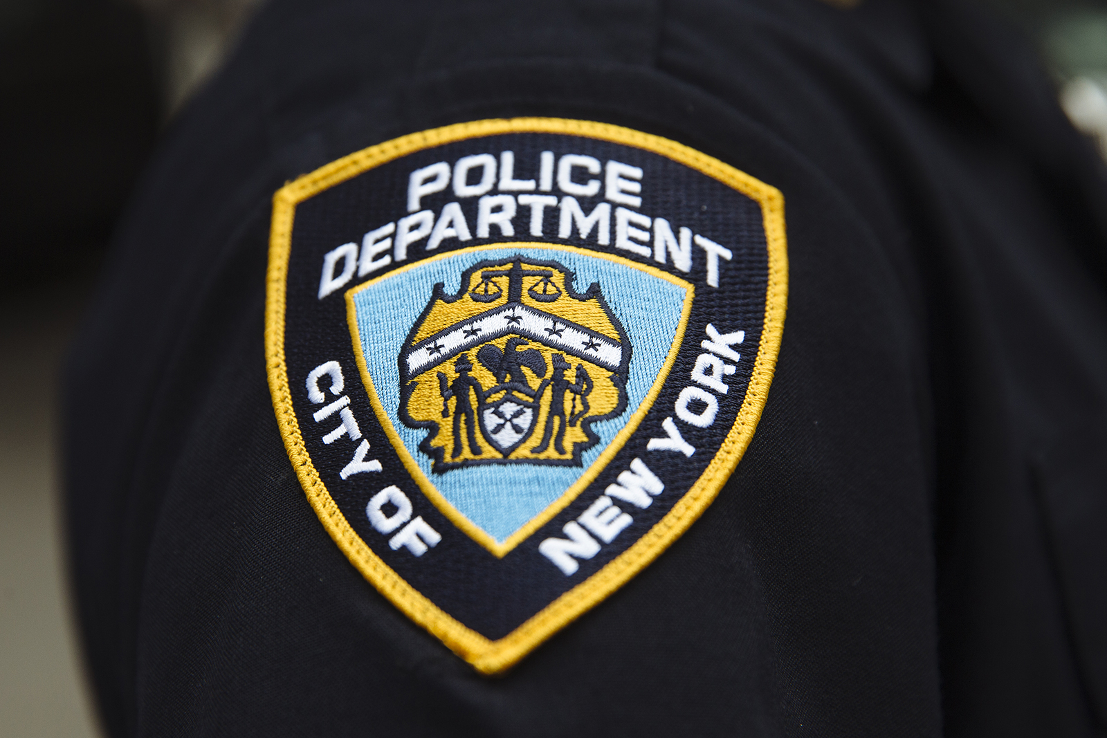 A New York City Police Department (NYPD) patch is seen on an officer's uniform.