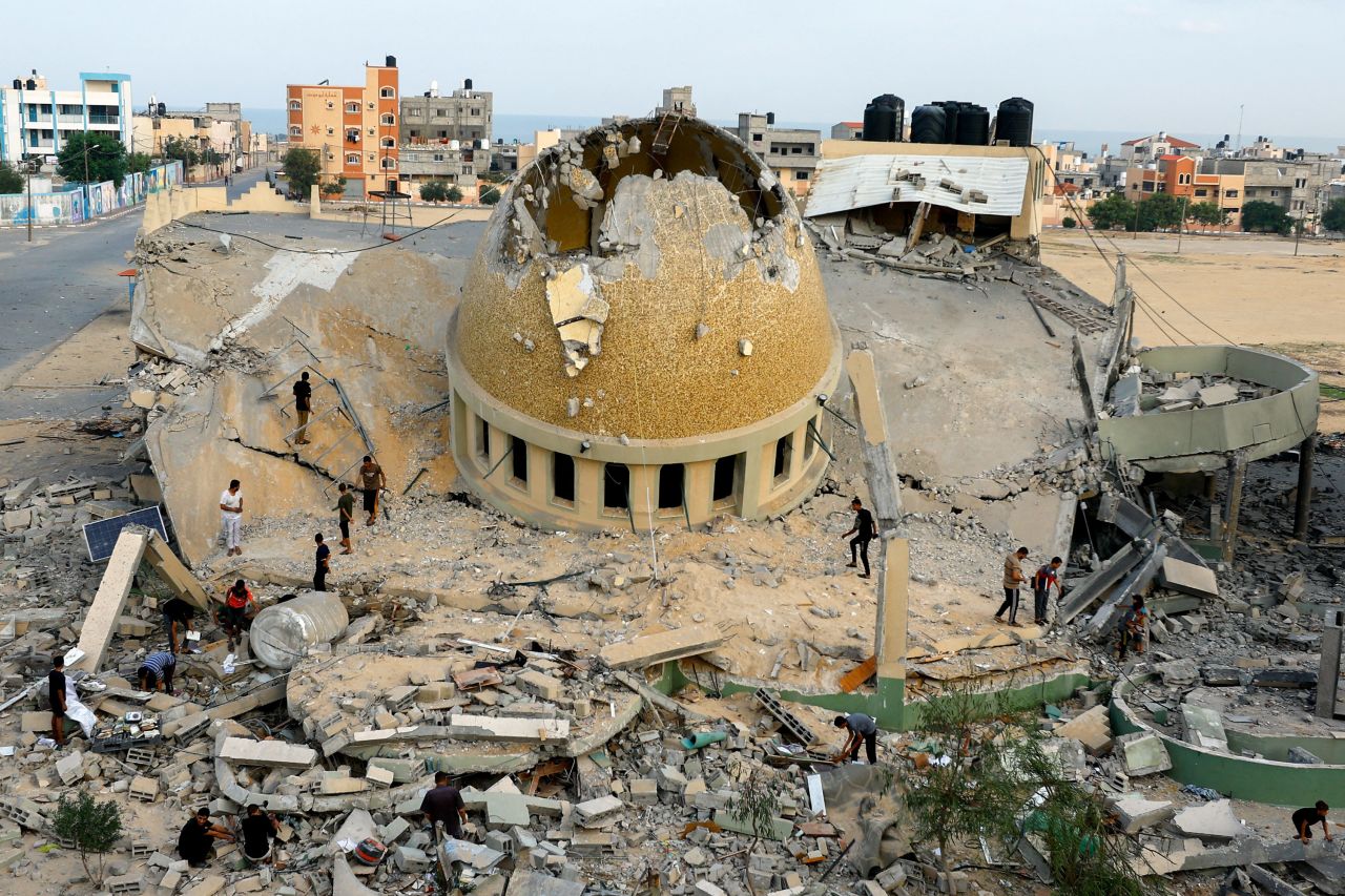 Palestinians inspect a mosque destroyed by Israeli air strikes in Khan Younis, Gaza, on Sunday, October 8. 