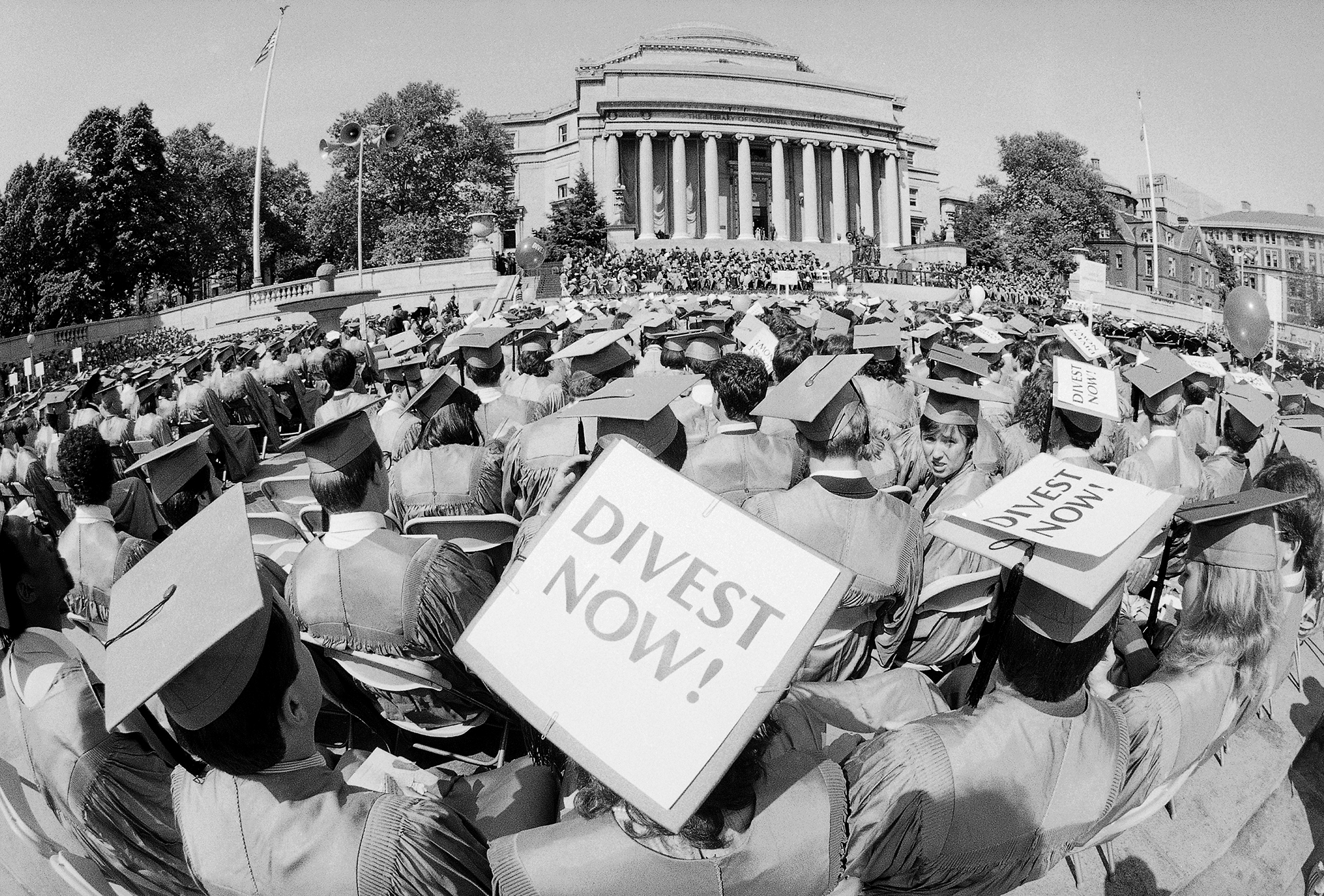 Some of the students graduating from New York's Columbia University use their motarboards to make known their views of the university's financing of companies operating in South Africa on May 15, 1985.