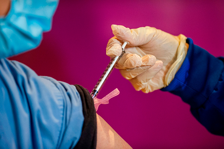 A nurse administers the second dose of the Pfizer/BioNTech vaccine to a health care worker at the Hartford Convention Center in Hartford, Connecticut on Monday, January 4. 