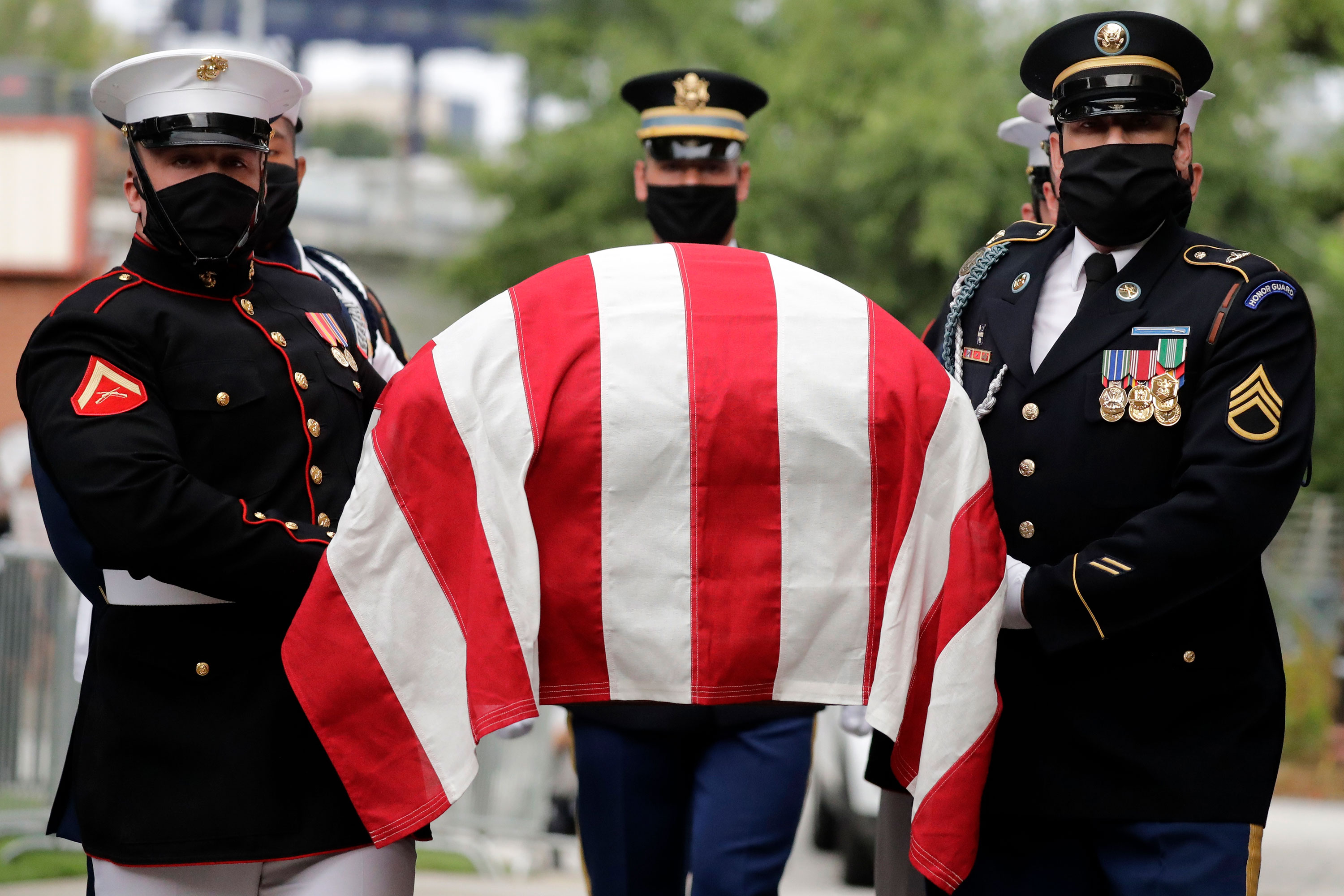 A military honor guard carries the casket of Rep. John Lewis into Ebenezer Baptist Church in Atlanta on July 30.