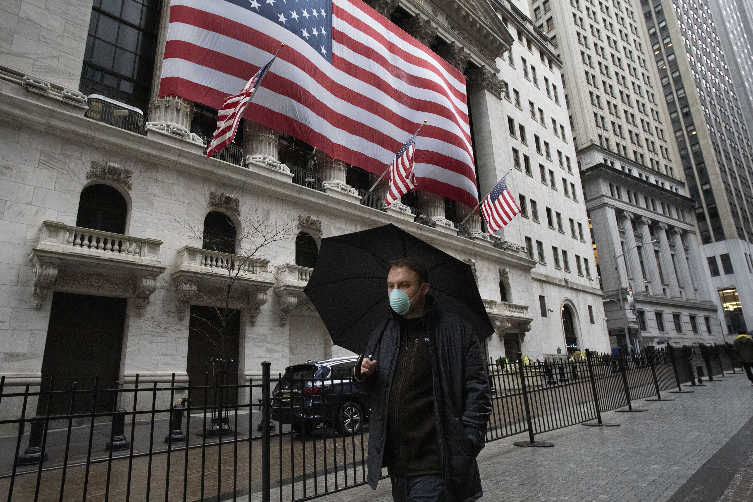 A pedestrian passes the New York Stock Exchange on Tuesday morning.