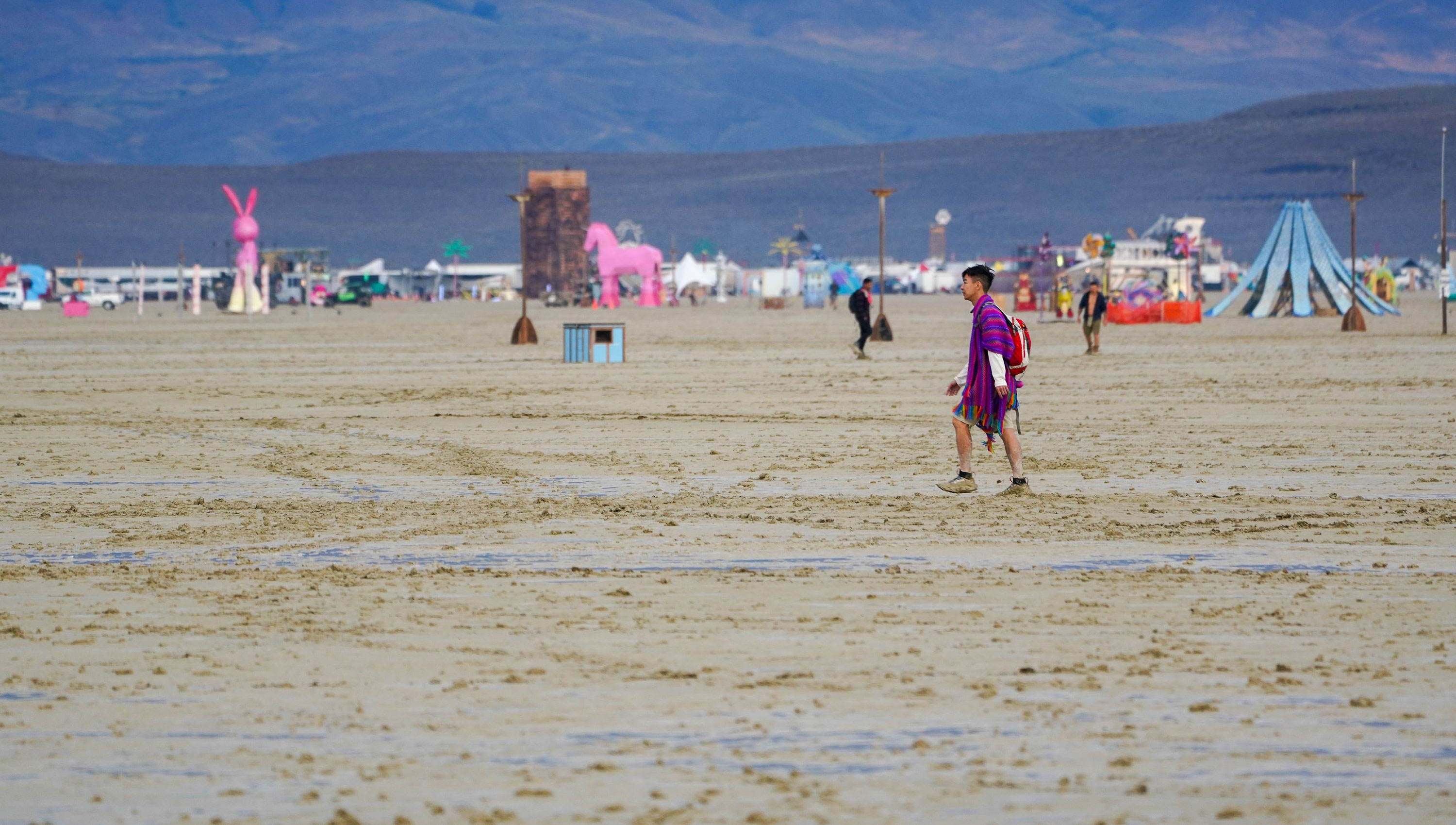 A festival attendee walks through mud at Burning Man on September 2, in Black Rock Desert, Nevada. 