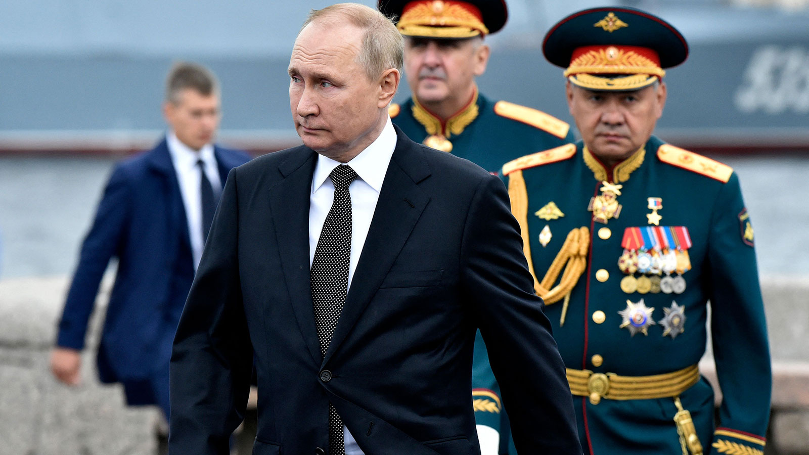 Russia's President Vladimir Putin, left, walks as he takes part in a naval parade in St. Petersburg on July 31. 