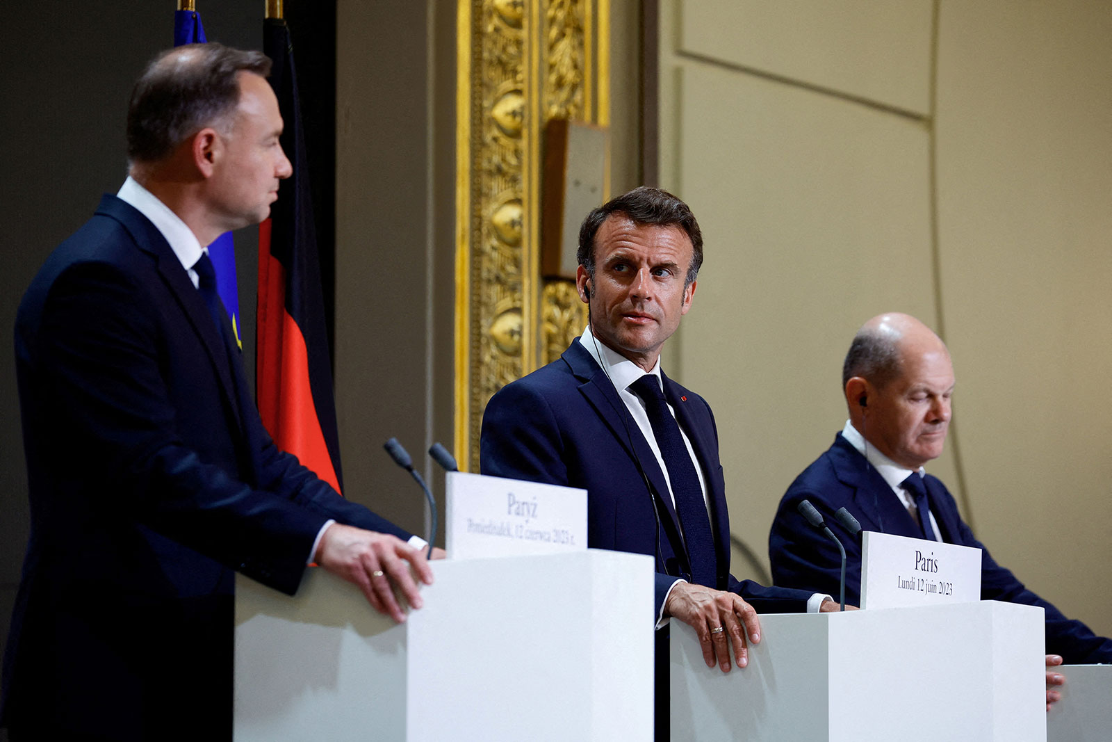 French President Emmanuel Macron, center, attends a news conference with German Chancellor Olaf Scholz, right, and Polish President Andrzej Duda in Paris, on Monday, June 12.
