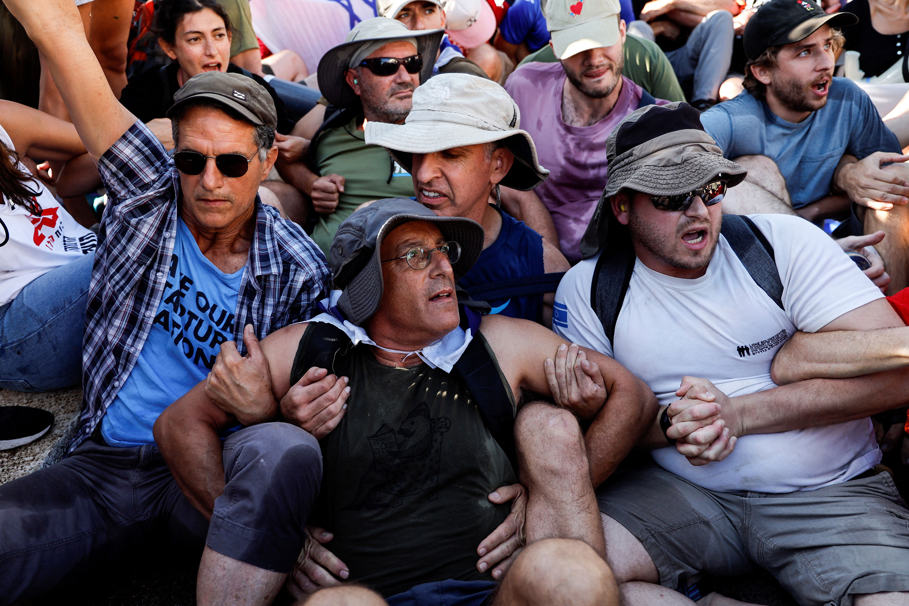 Protesters link arms as they attempt to block a road leading to the Knesset in Jerusalem on Monday.