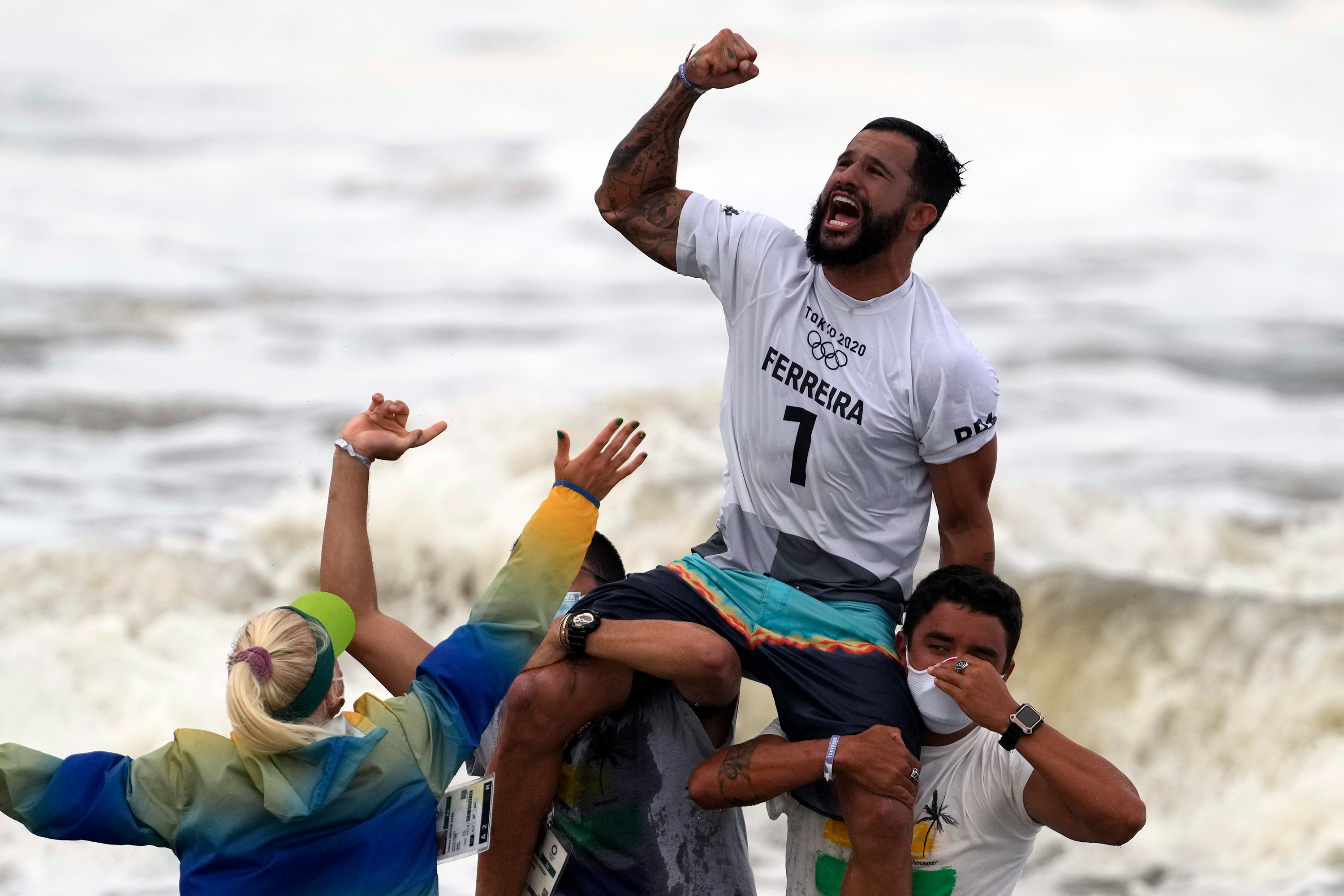 Brazil's Italo Ferreira celebrates winning the gold medal in the men's surfing competition on Tuesday, July 27. 