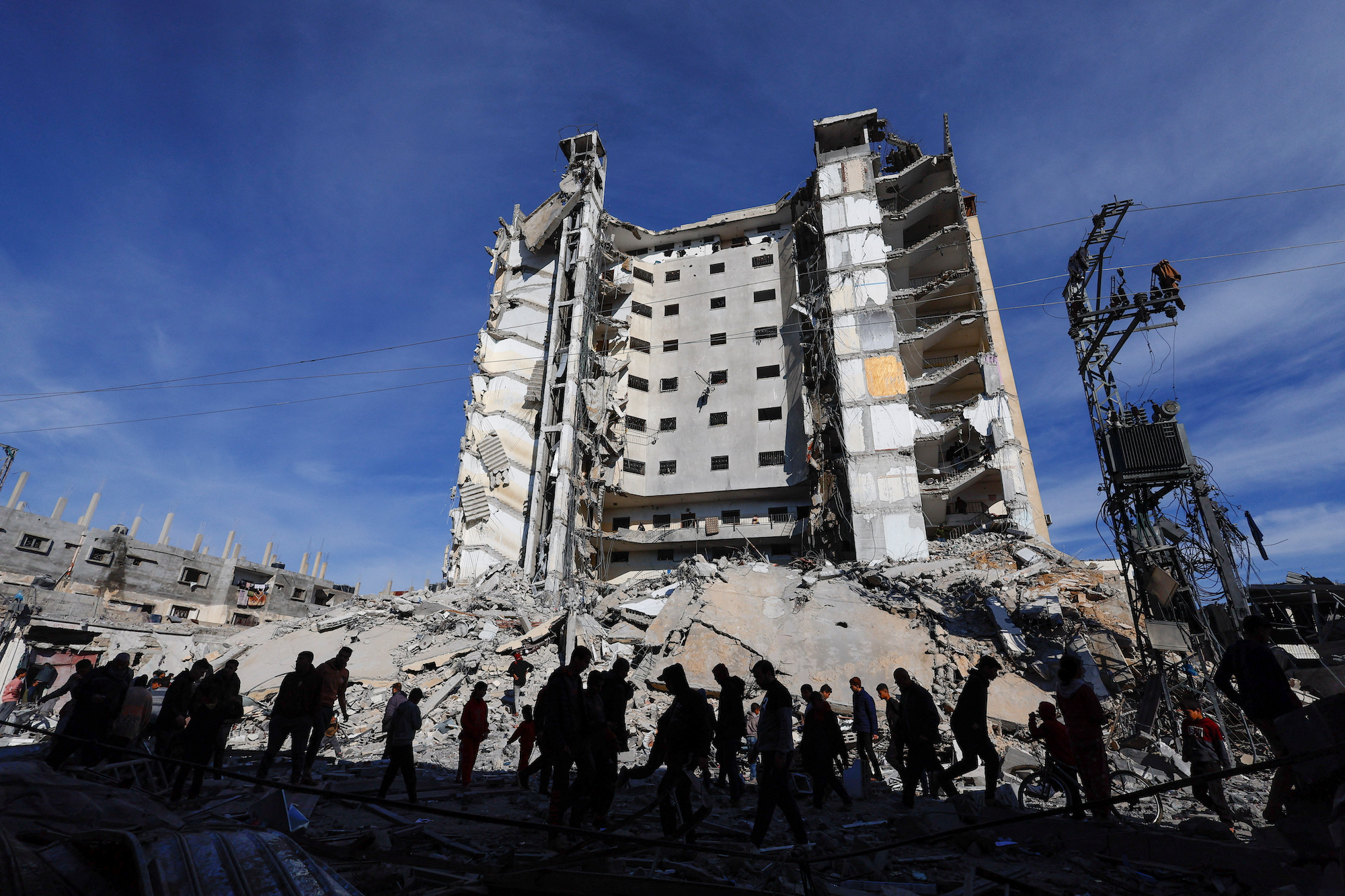 Palestinians gather near a building damaged in an Israeli air strike in Rafah, Gaza, on Saturday.