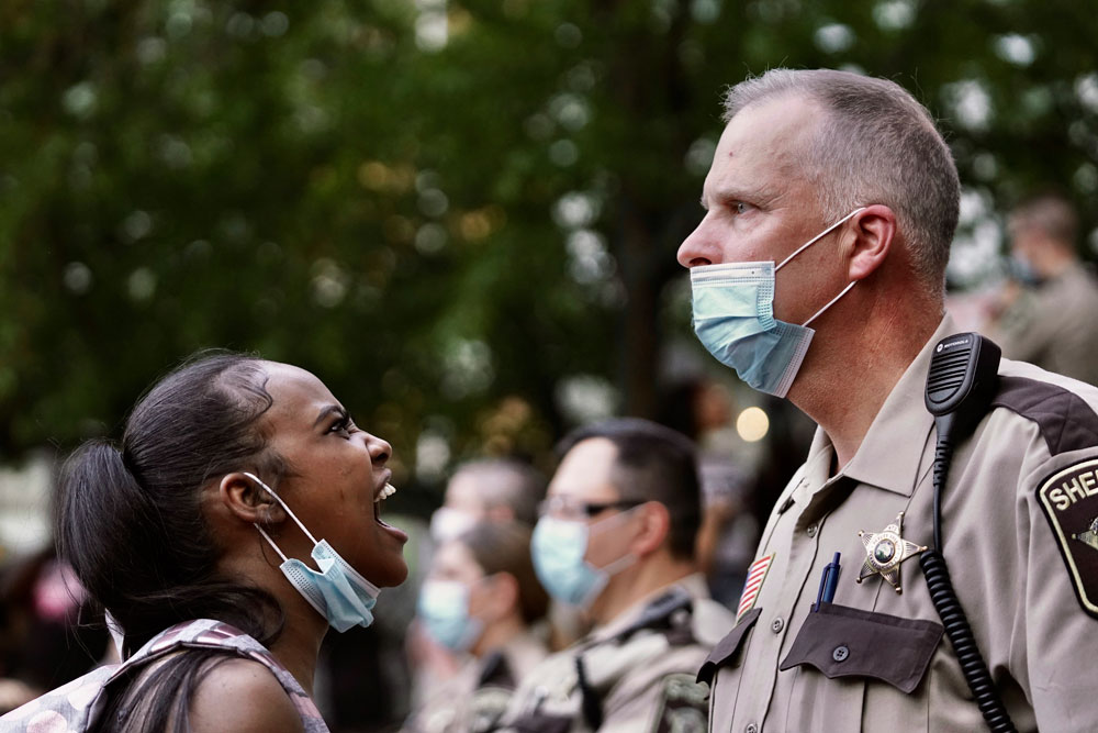 A woman yells at a sheriff's deputy during a protest following the death of George Floyd at the hand of Minneapolis police officers, on Thursday, May 28 in Minneapolis.