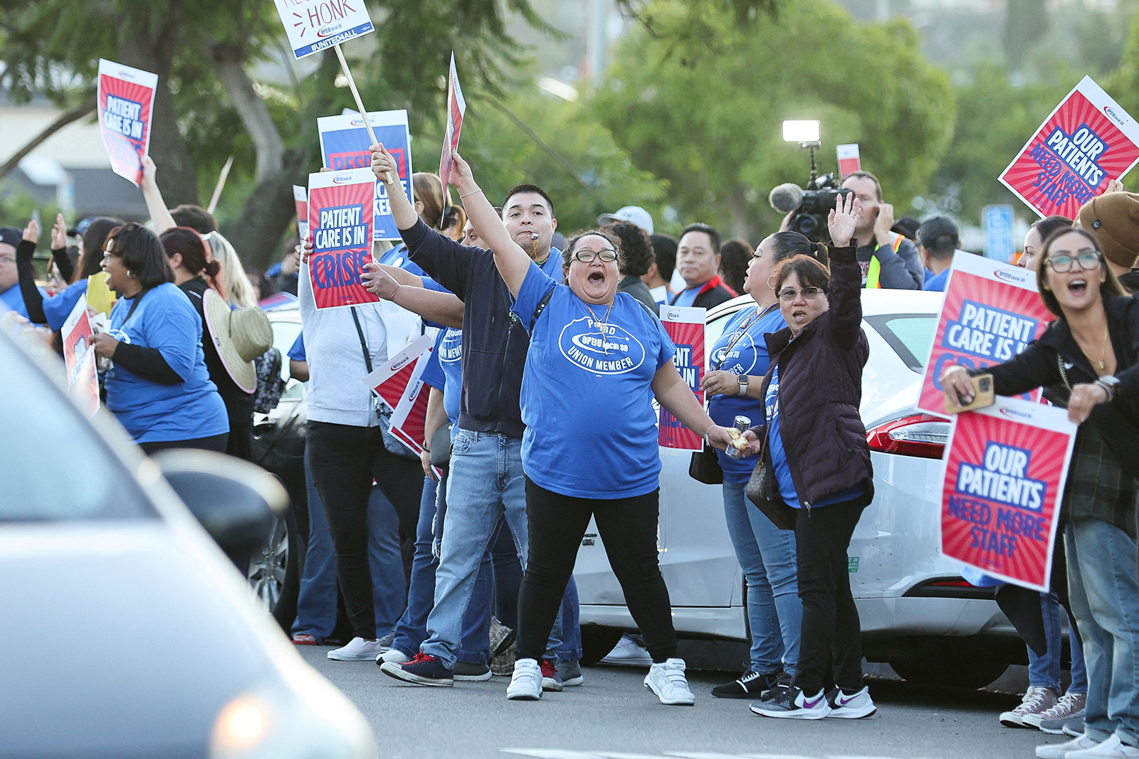 Les gens brandissent des pancartes alors qu'une coalition de syndicats de Kaiser Permanente représentant 75 000 travailleurs de la santé de Kaiser Permanente entame une grève de trois jours à travers les États-Unis au sujet d'un nouveau contrat, à San Diego, en Californie, le 4 octobre.