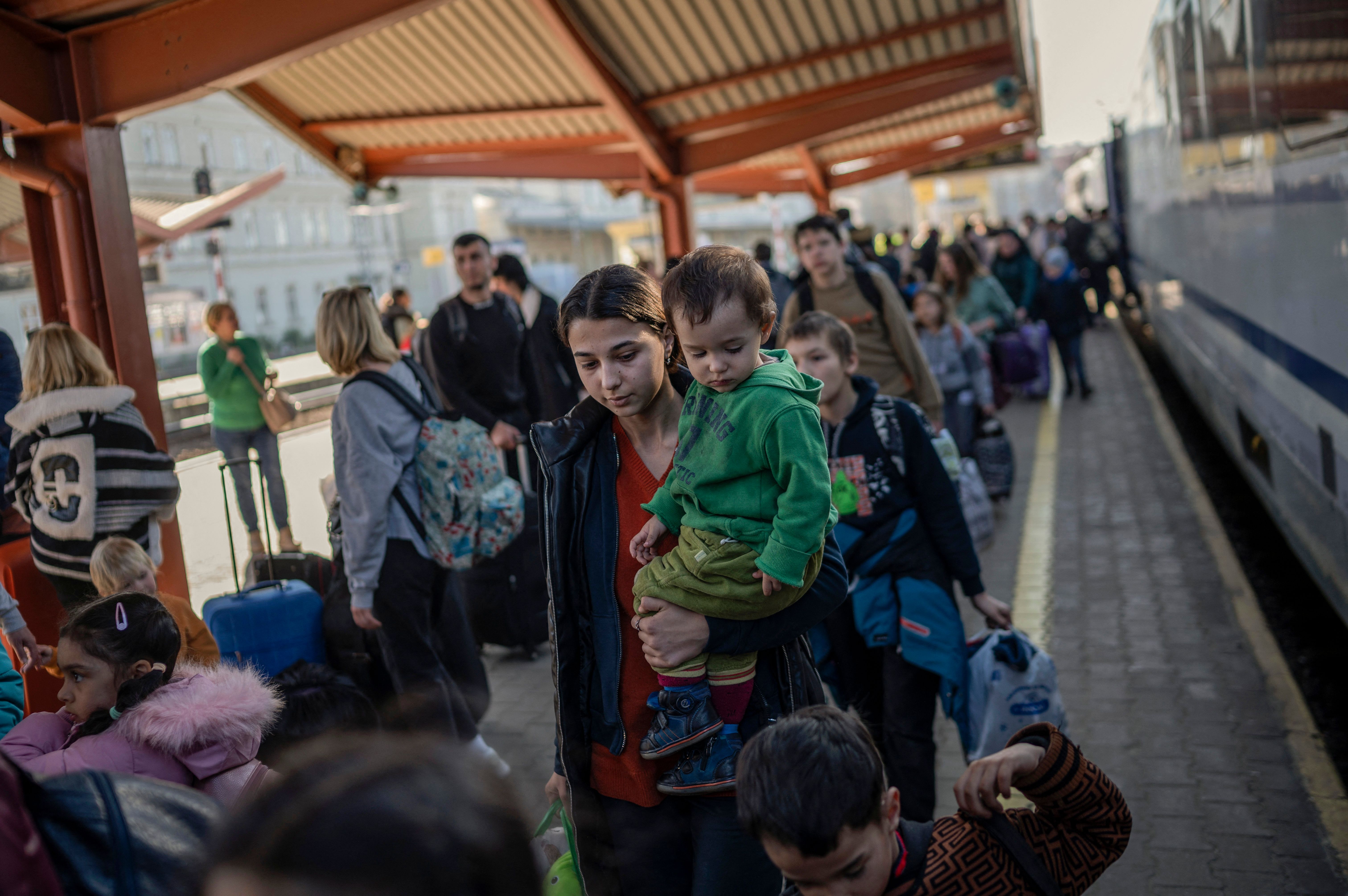 Ukrainian evacuees board a train to Warsaw at the rail station in Przemysl, Poland, on March 23.