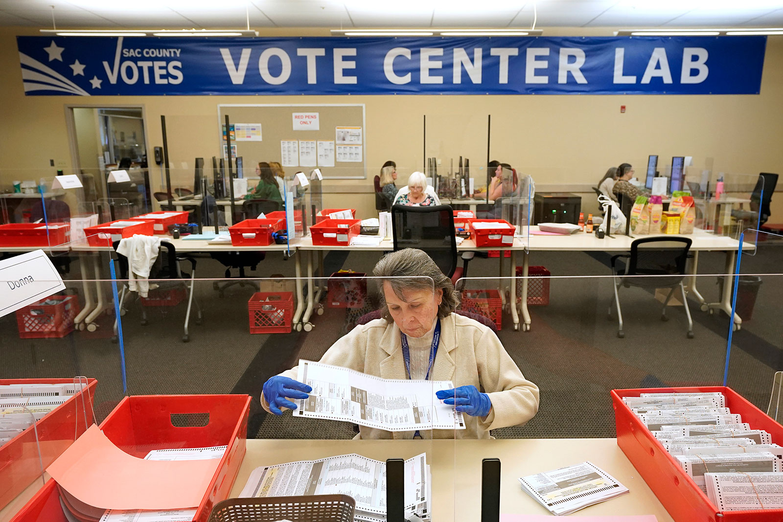 Election worker Donna Young inspects a mail-in ballot for damage at the Sacramento County Registrar of Voters in Sacramento, California, on June 3. 