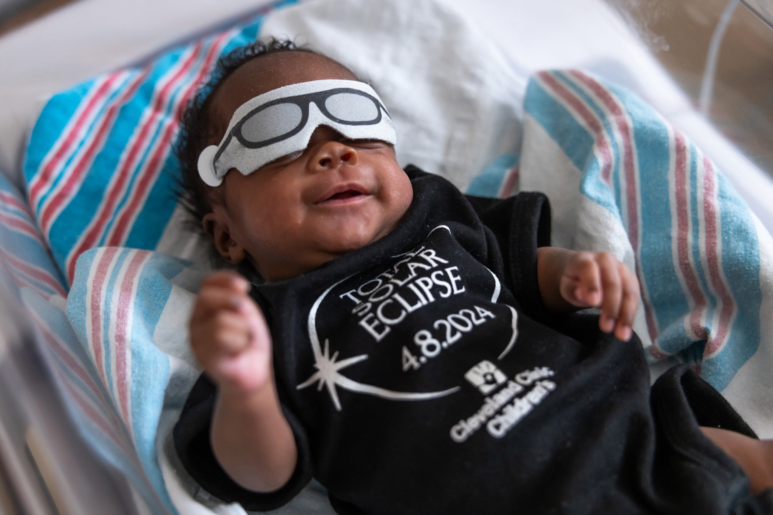Baby Teagan wears an eclipse onesie and glasses at the Cleveland Clinic Children’s NICU at Hillcrest Hospital in Mayfield Heights, Ohio, on April 8.