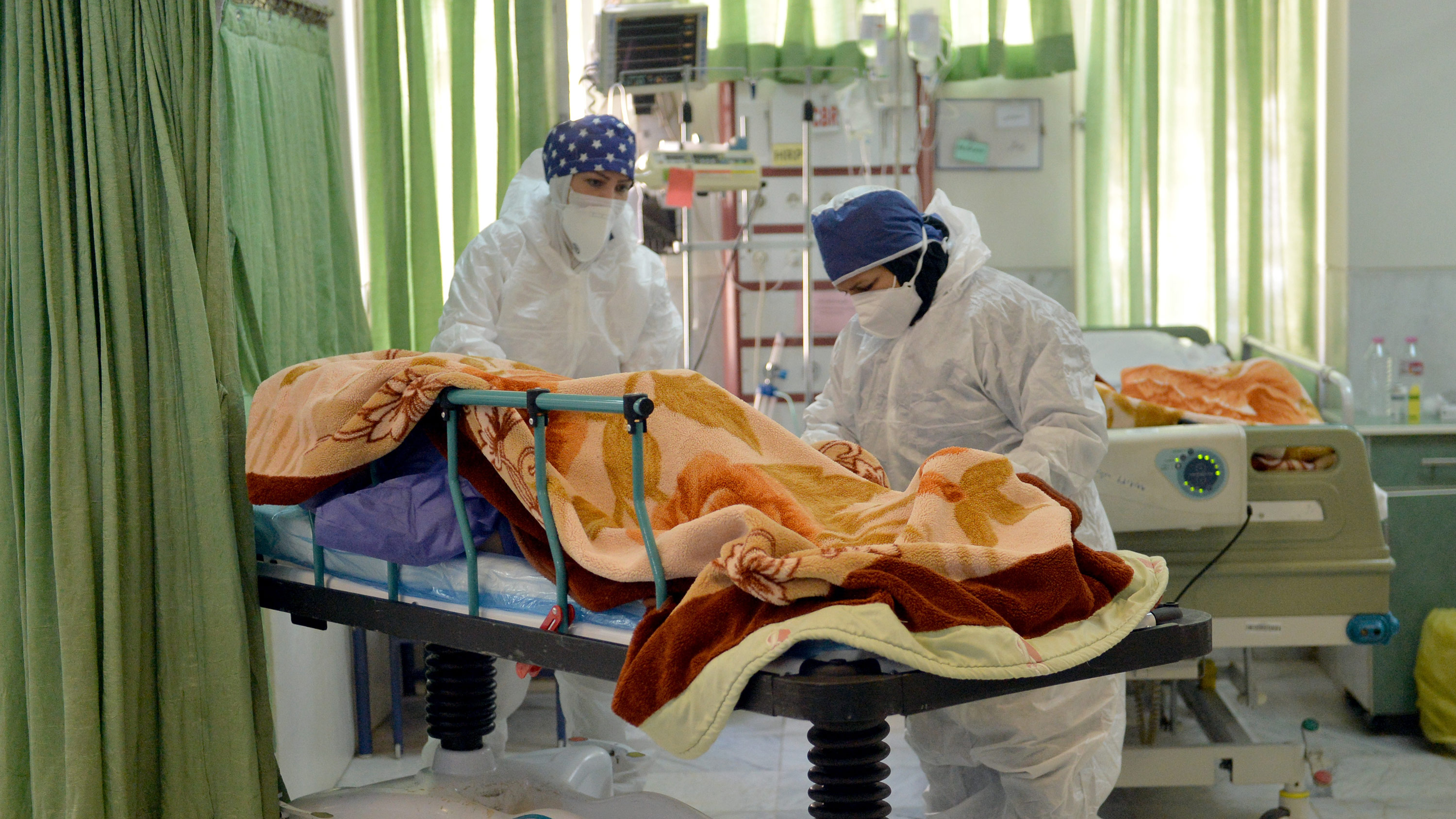 Healthcare staff tend to a Covid-19 patient in the intensive care unit of Firouzabadi Hospital in Tehran, Iran, on December 20, 2020. 