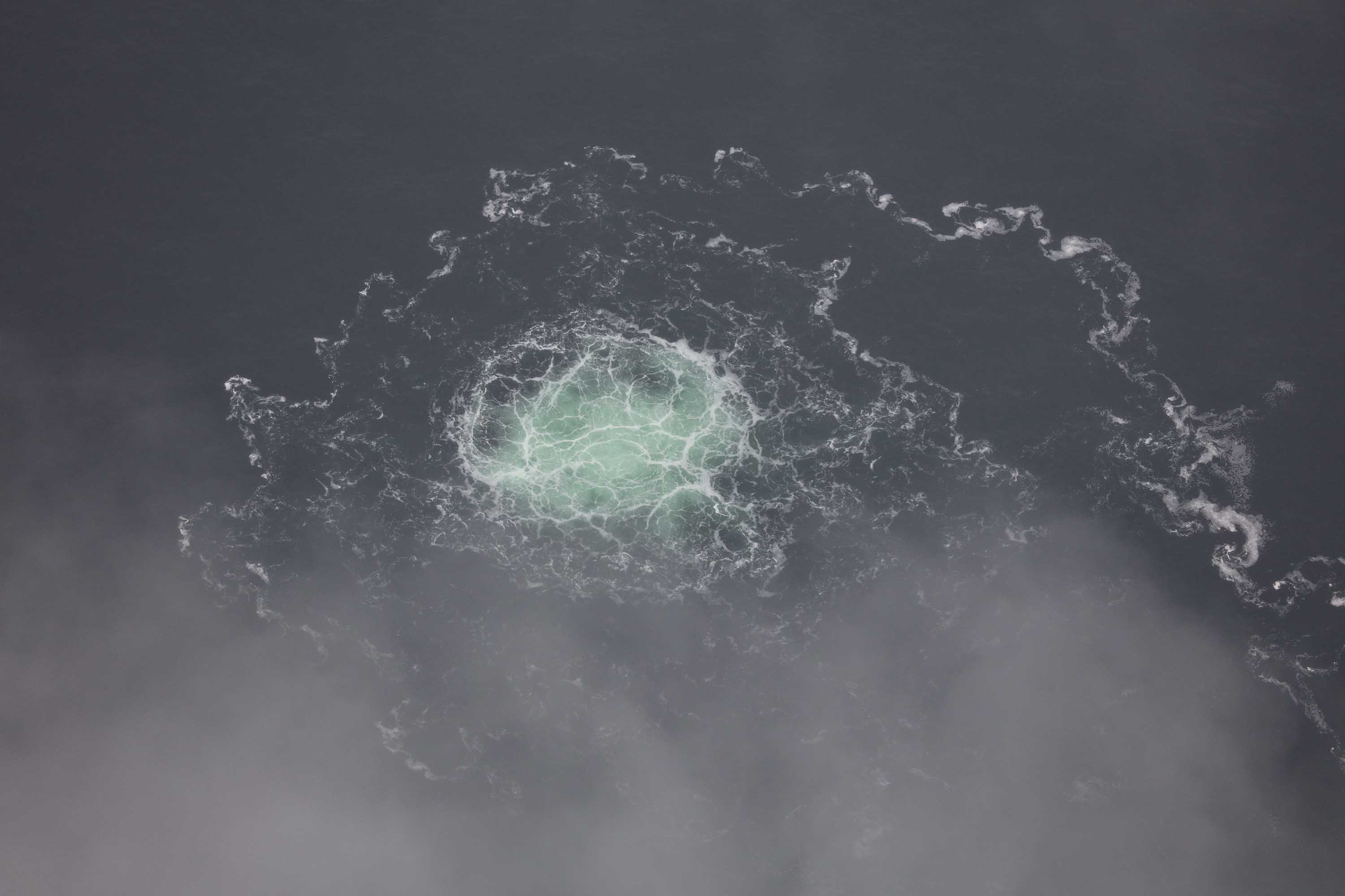 The release of gas is seen bubbling on the surface of the Baltic Sea from a leak on the Nord Stream 2 gas pipeline, on September 28, 2022, in a handout photo provided by the Swedish Coast Guard.