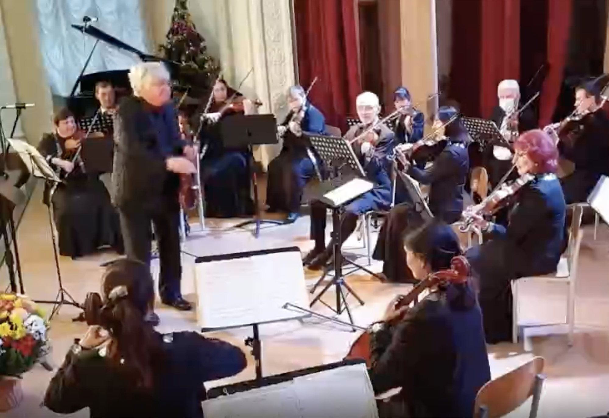 A screen grab from a video shows conductor Yuriy Kerpatenko conducting an orchestra.