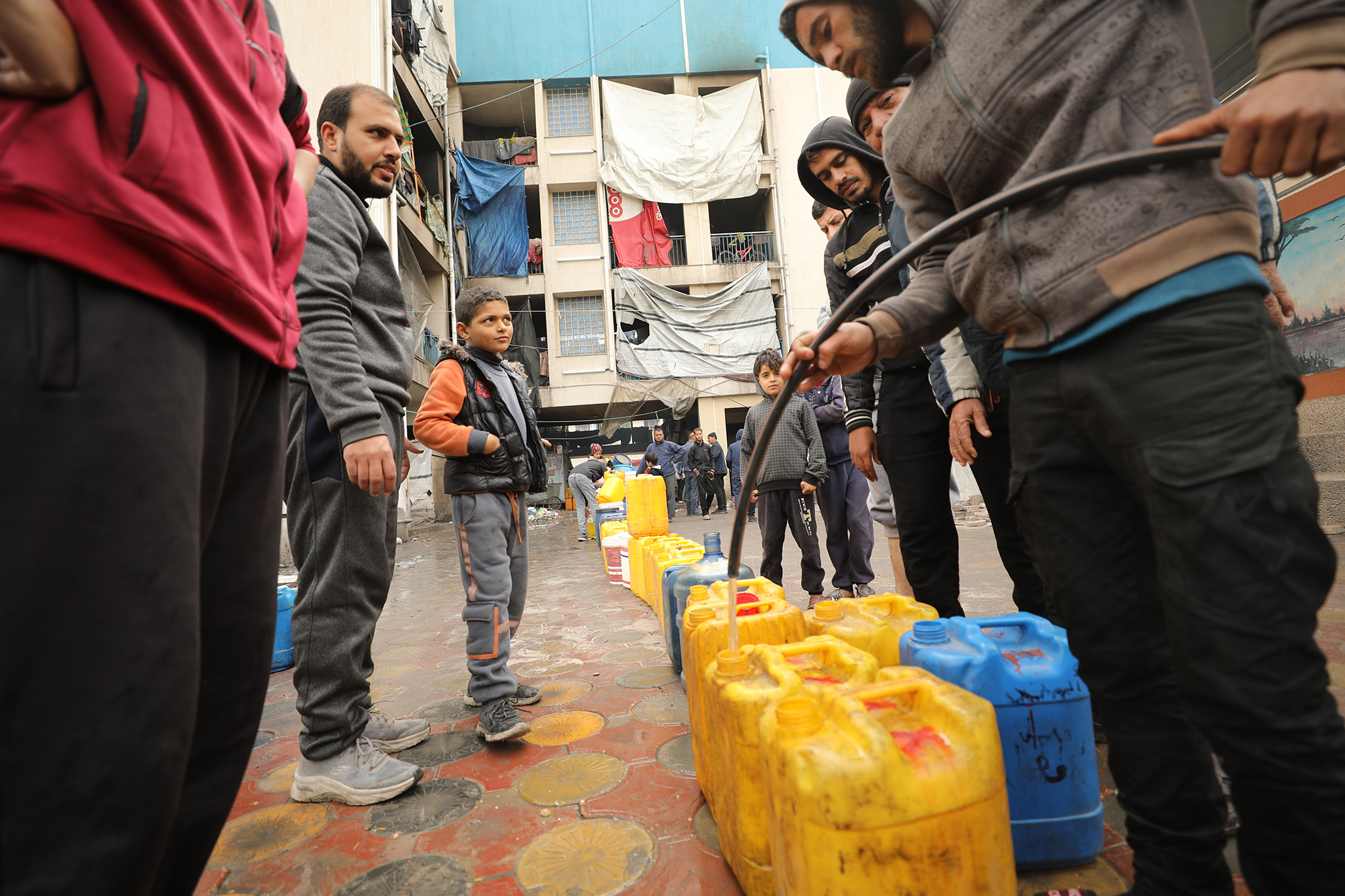 Palestinians fill containers with water in Gaza City on March 3. 