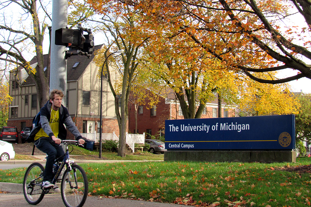 A cyclist rides through University of Michigan's central campus on October 25, 2017.