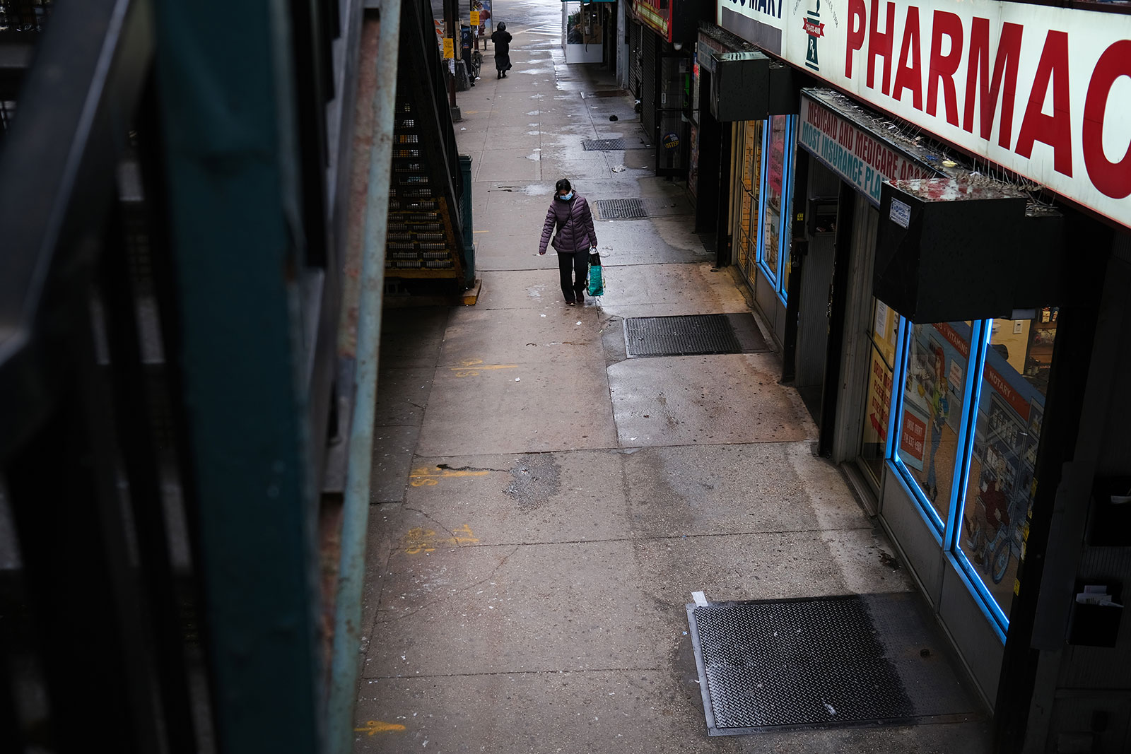 A person walks down a sidewalk in Brooklyn, New York, on March 28. 