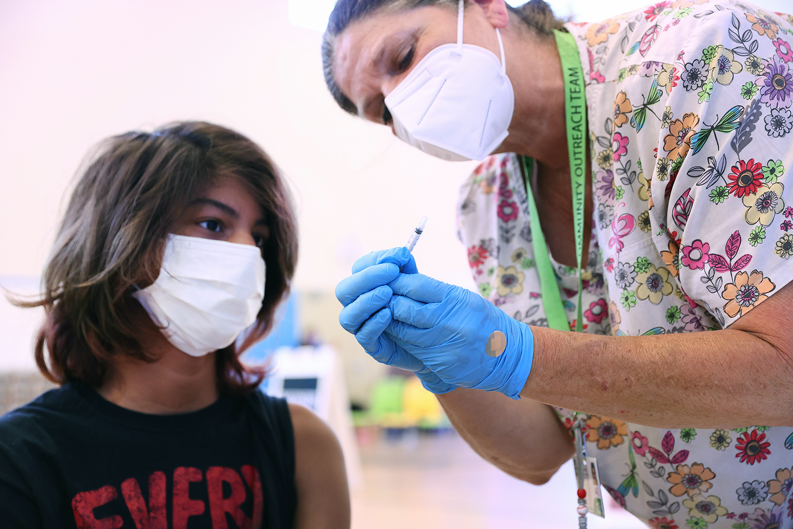 Registered nurse Sue Dillon explains the vaccination process to a student before administering a dose of the Pfizer vaccine at a three-day vaccination clinic on July 29, in Wilmington, California.
