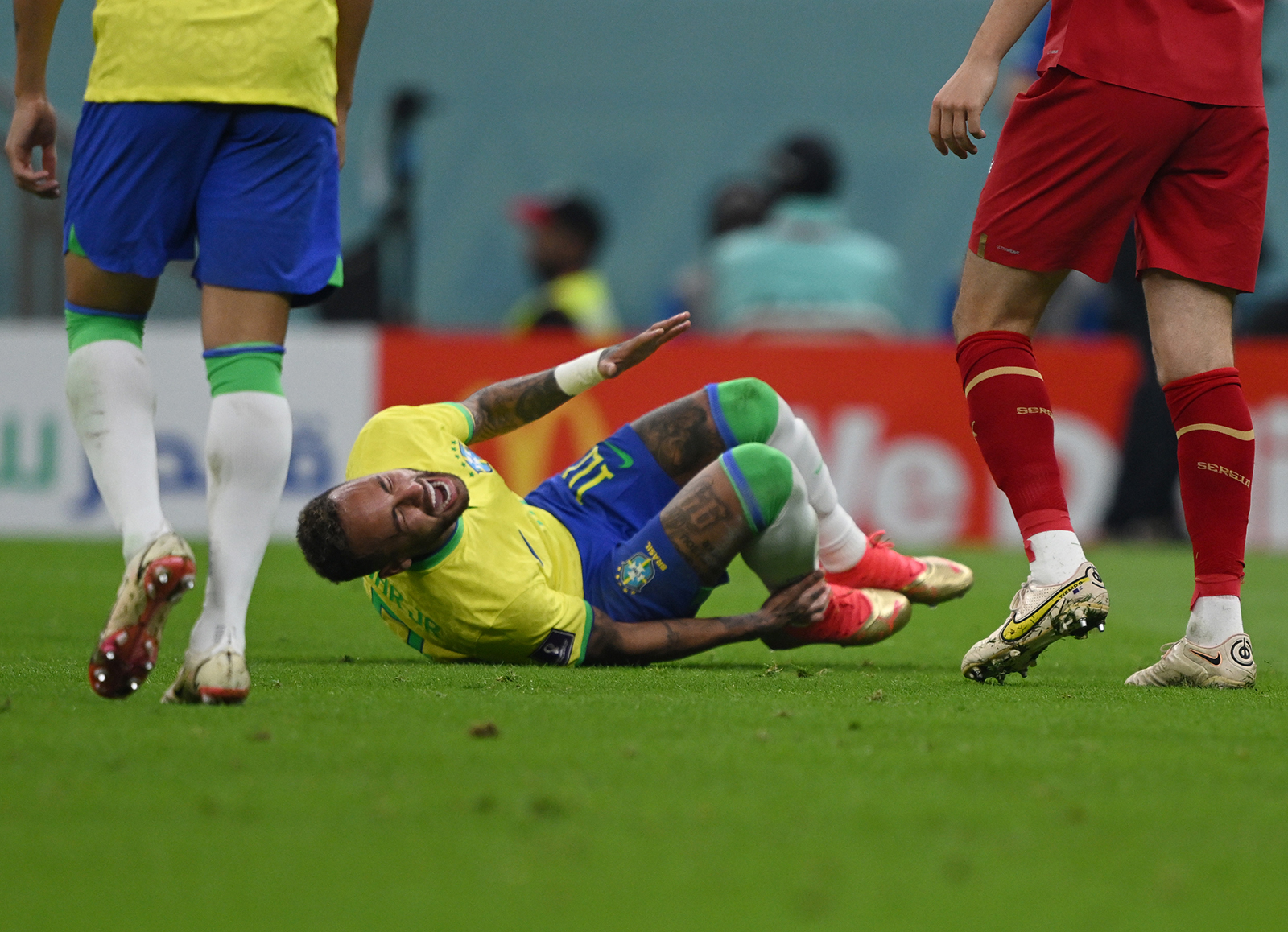 Neymar of Brazil lies on the turf with his face contorted in pain, holding his ankle. Photo: Robert Michael/dpa (Photo by Robert Michael/picture alliance via Getty Images)