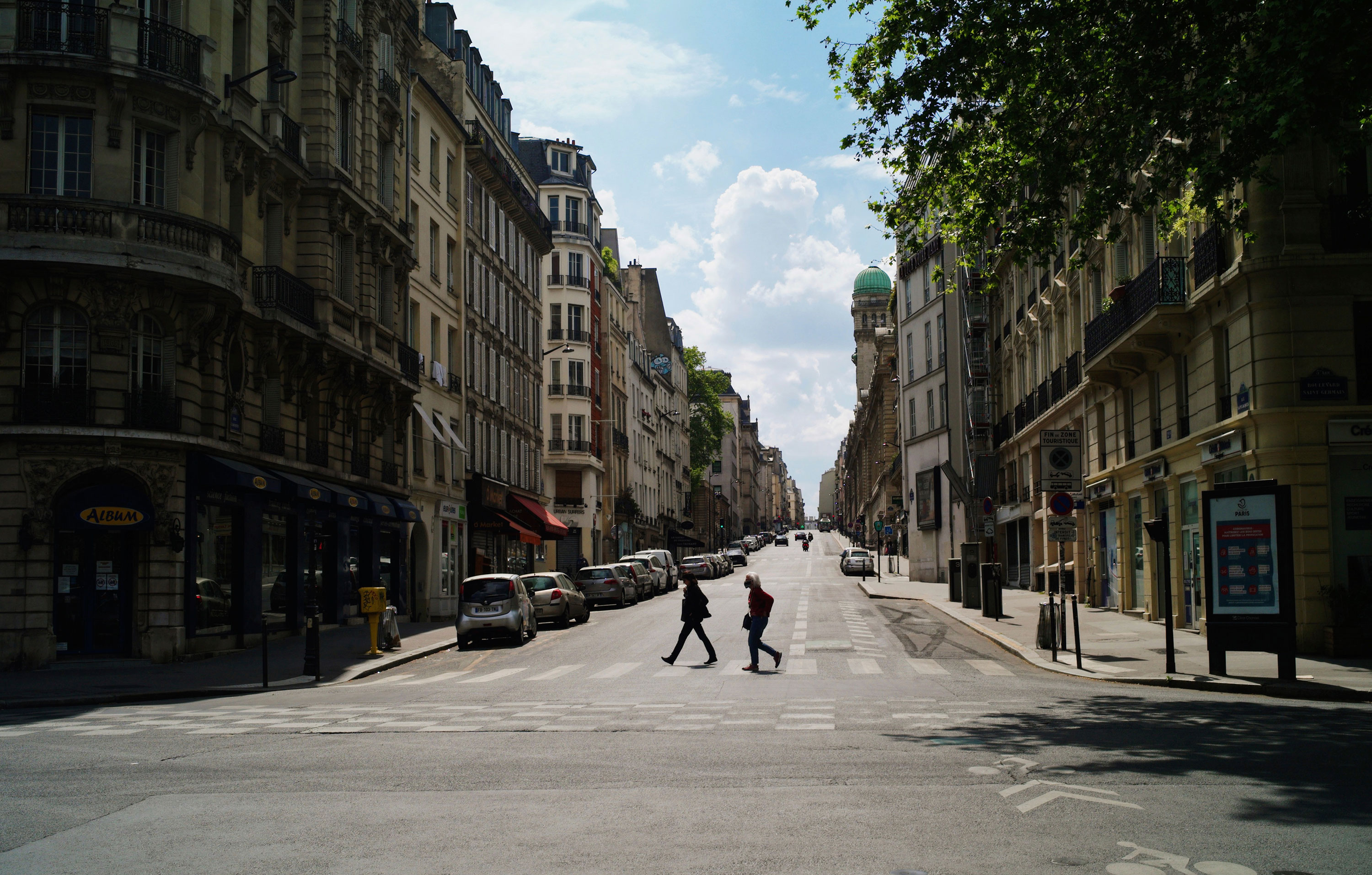People cross a deserted street in Paris, France, on April 27.