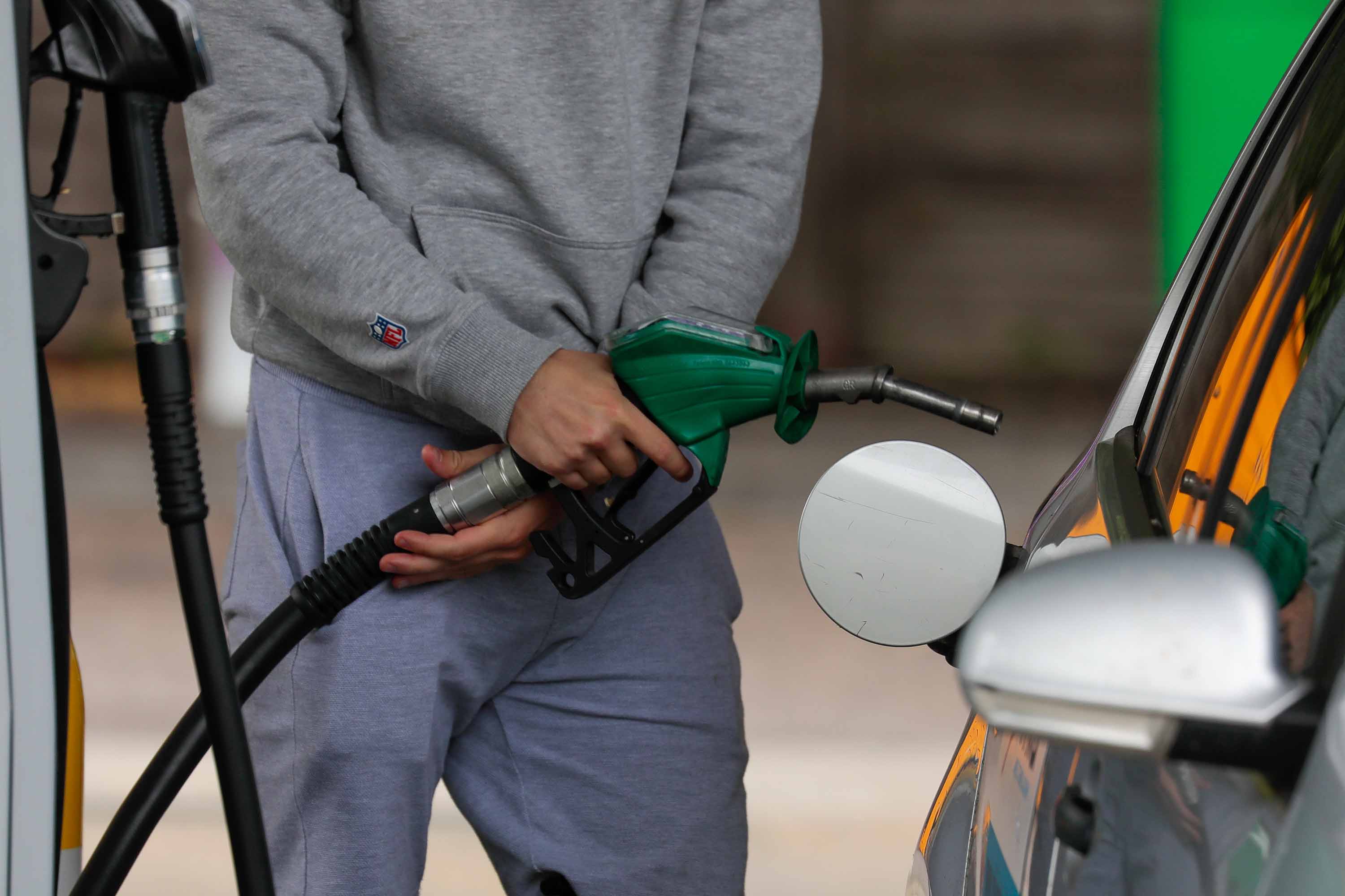 A customer fills up at a BP Plc station in Cambridge, England, on June 8.