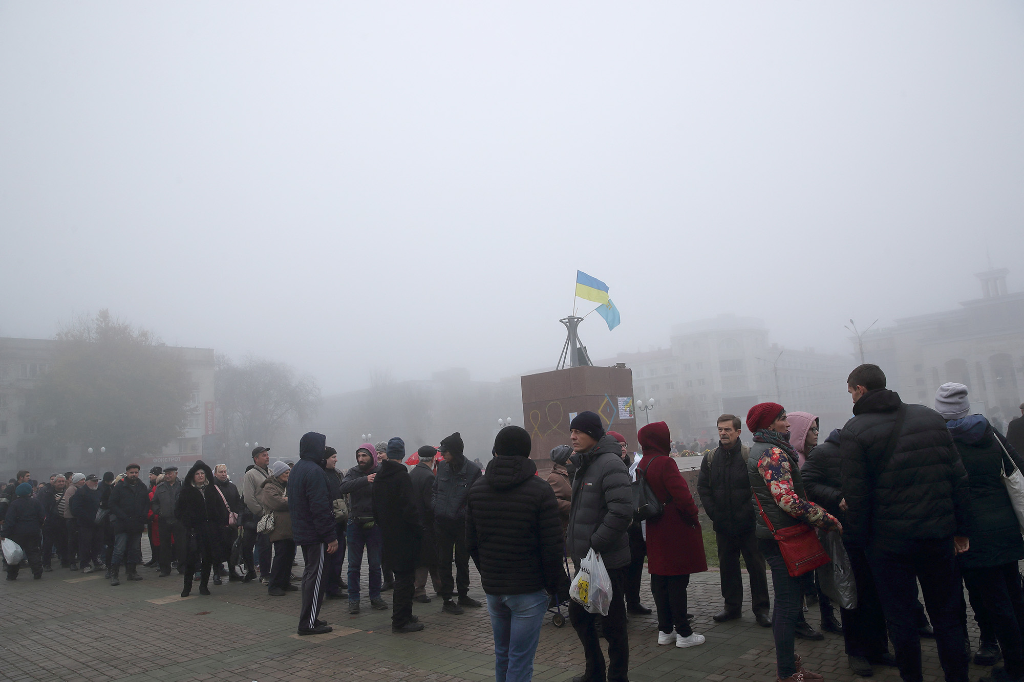 People wait in line to buy SIM cards in the central square of Kherson, Ukraine, on November 21.