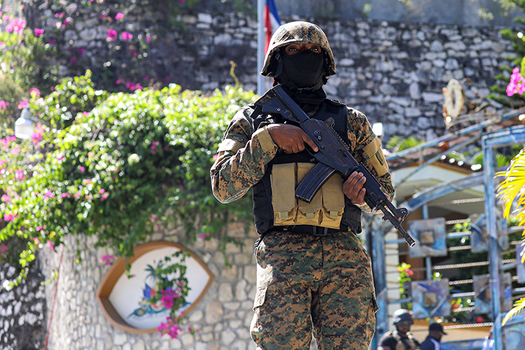 A Haitian police officer stands guard outside of the presidential residence on July 7,  in Port-au-Prince, Haiti. 