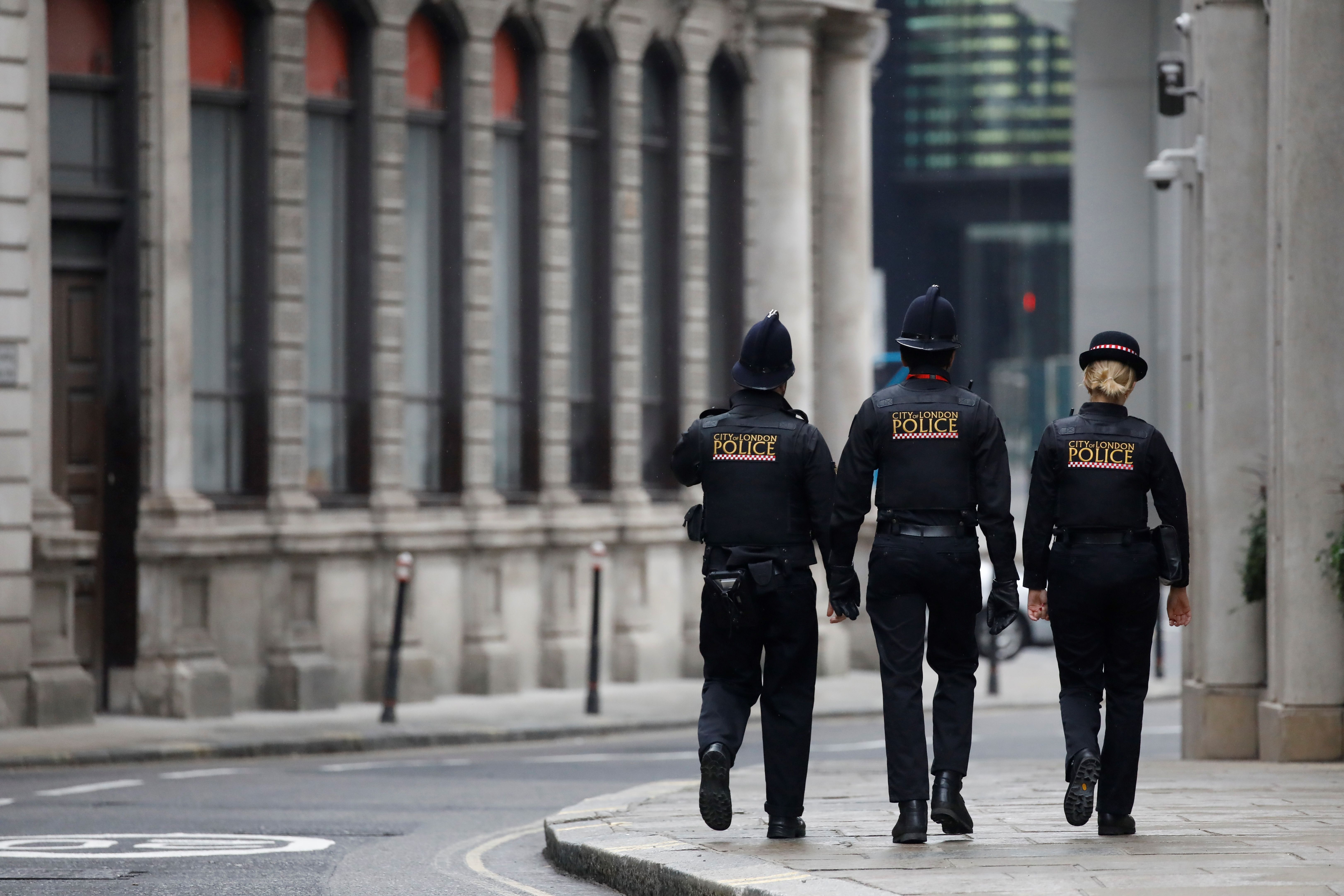 Police officers patrol the near-deserted streets in London on April 16.