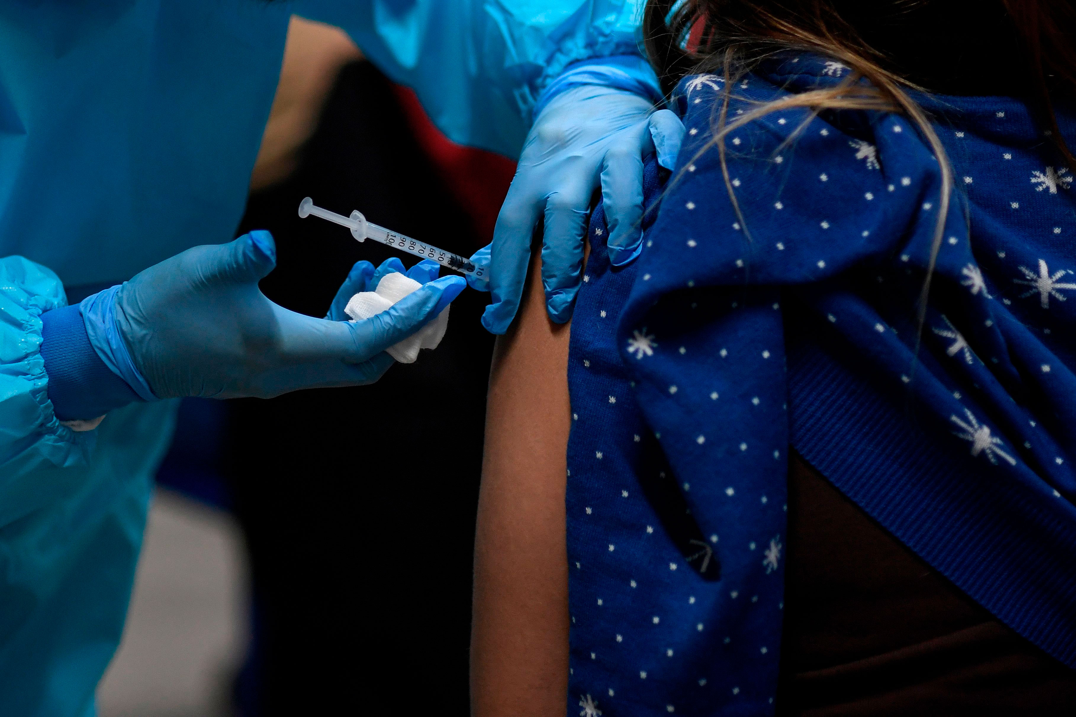 A health worker administers the Pfizer/BioNTech Covid-19 vaccine to a member of the Emergency Medical Services of Madrid (SUMMA) in Spain on January 12.