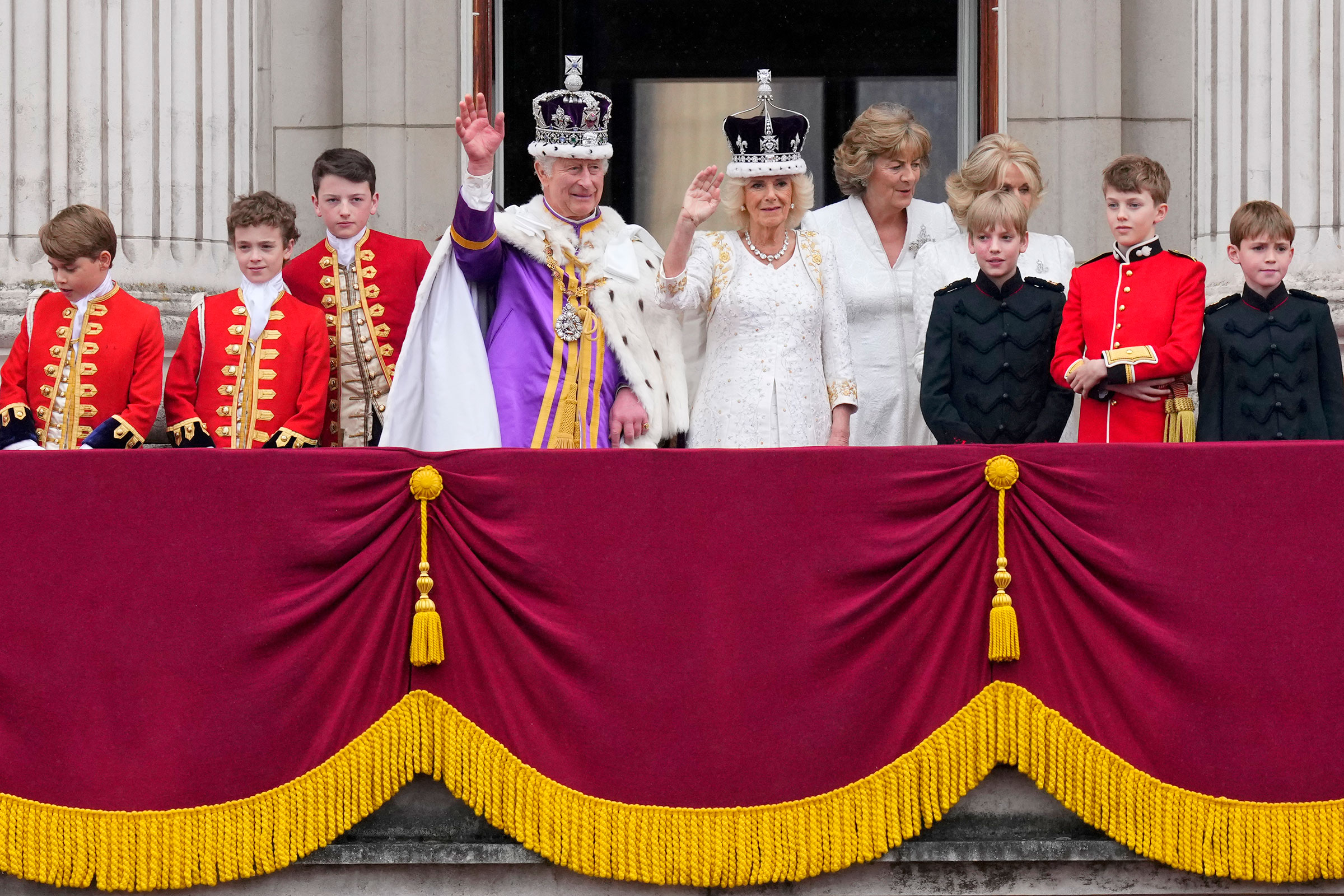Britain's King Charles III and Queen Camilla wave to the crowds from the balcony of Buckingham Palace after their coronation ceremony.