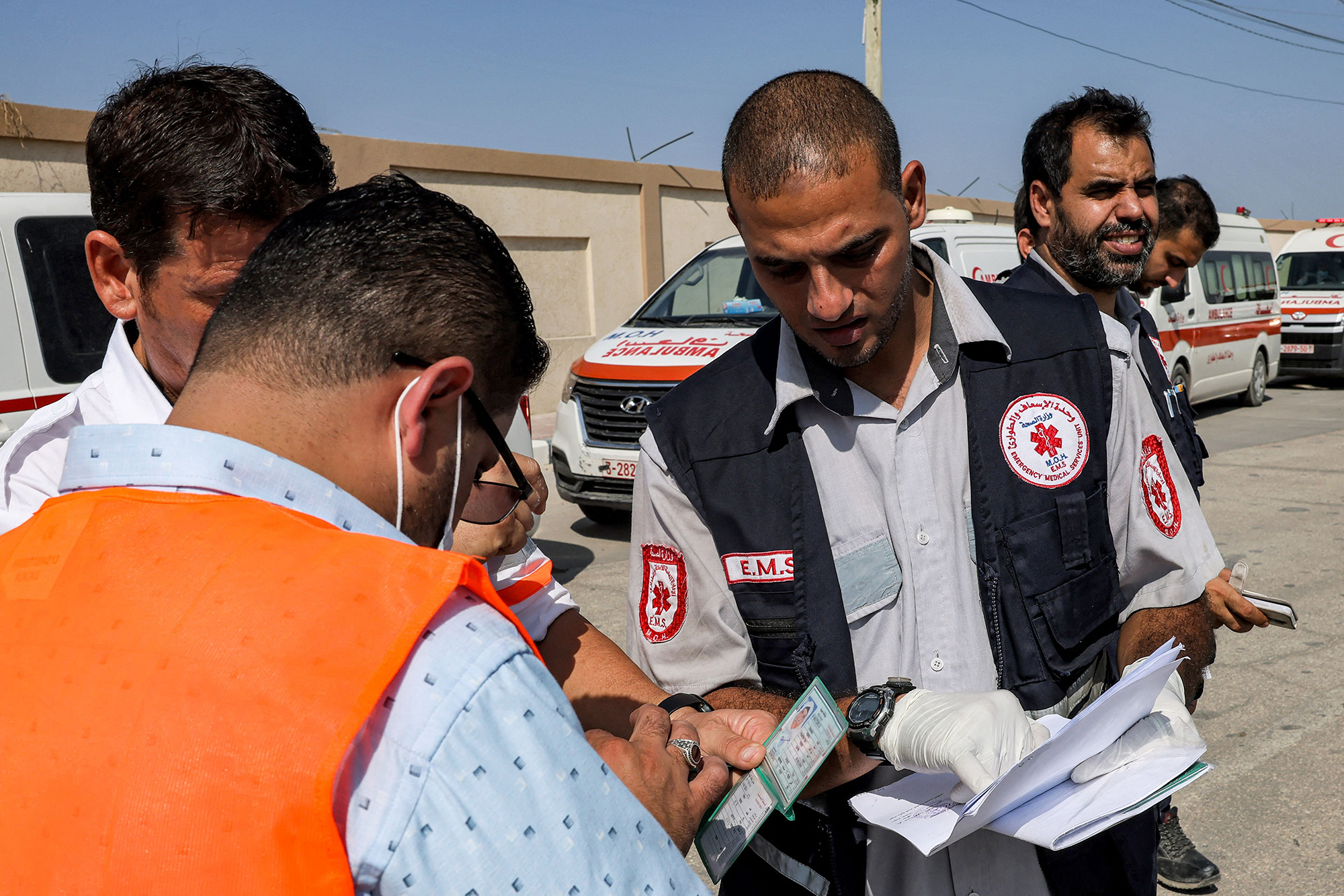 Palestinian health ministry paramedics check the travel documents of a person waiting to cross to Egypt at the Rafah border crossing on November 1. 