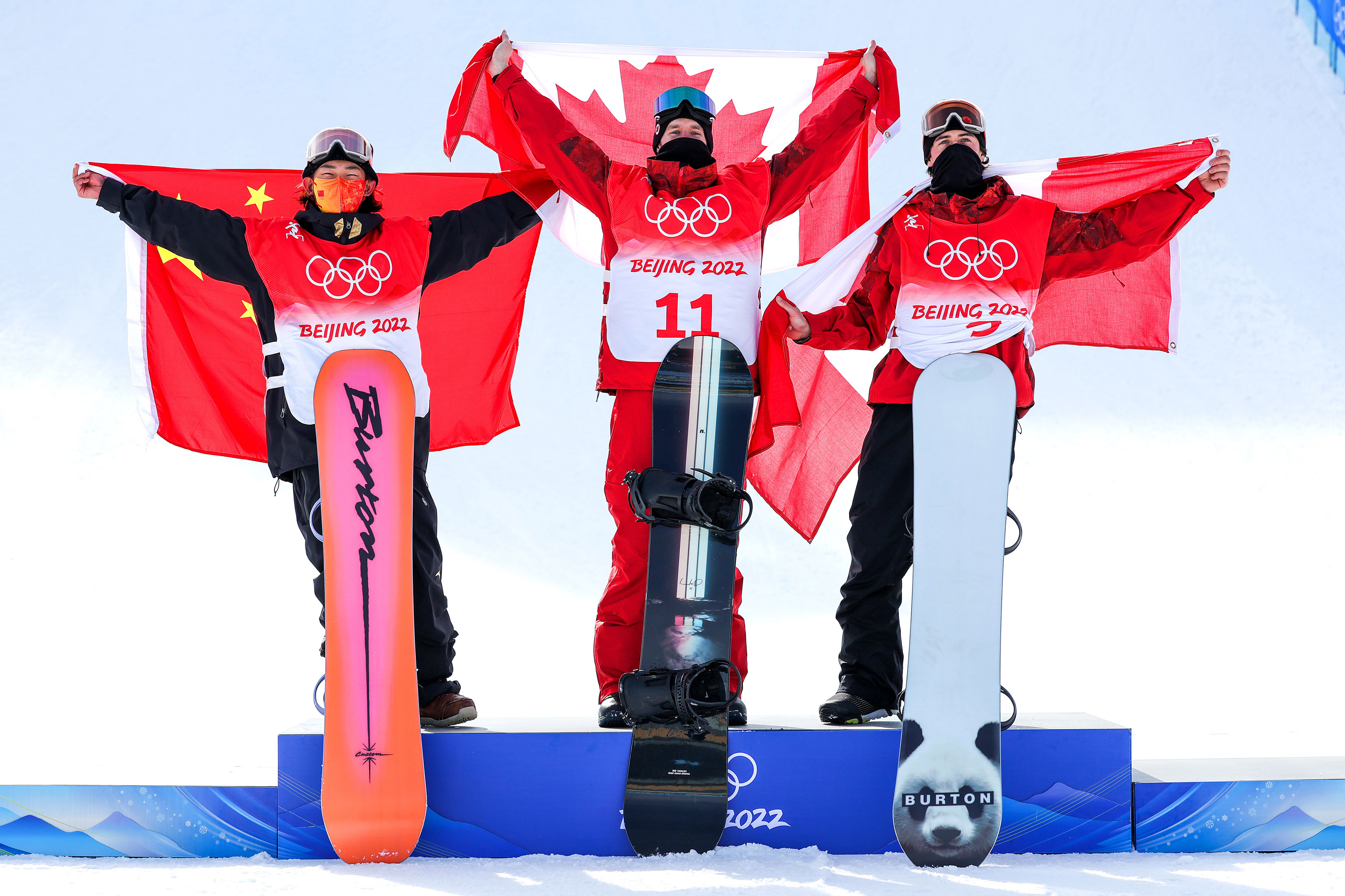 Medal winners Su Yuming (silver) from China, and Canada's Max Parrot (gold) and Mark Morris (bronze) line up on the podium.