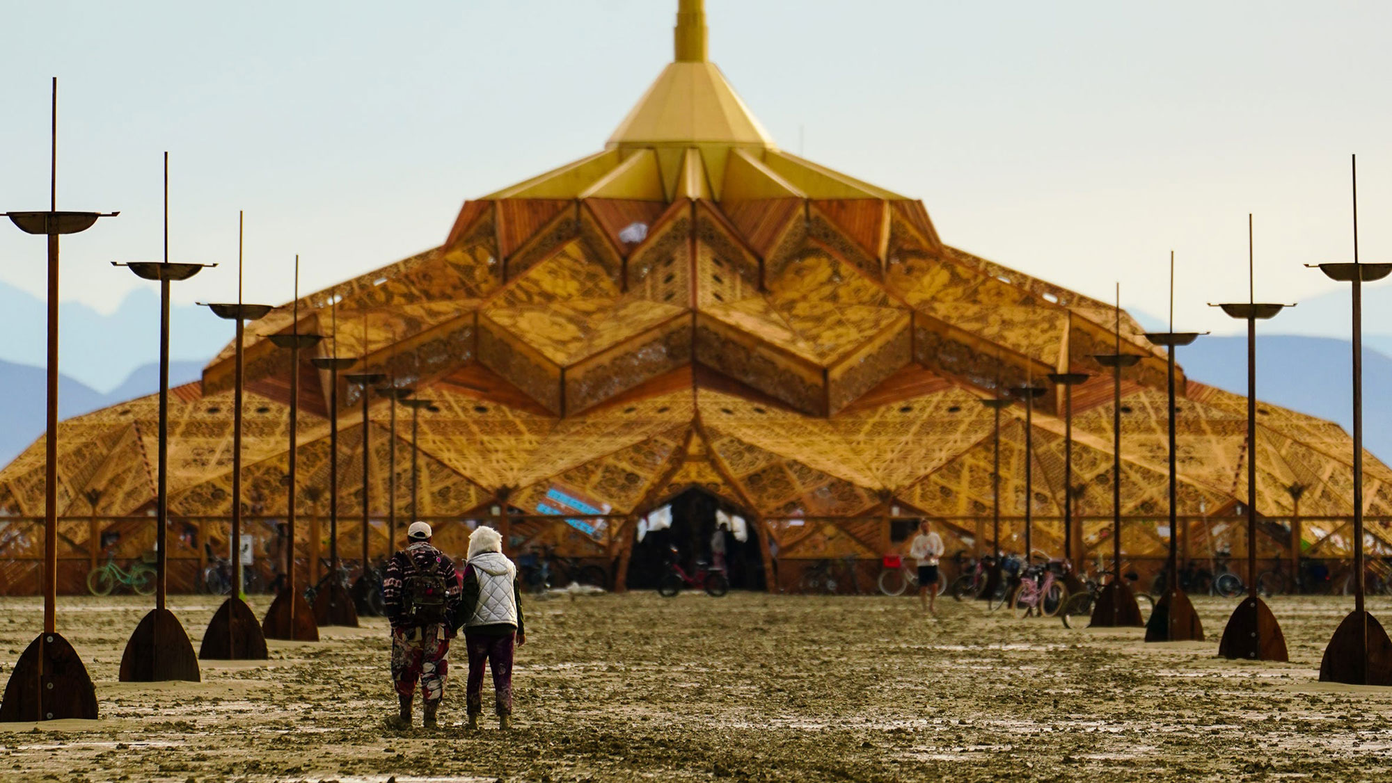 Festival attendees walk through mud at Burning Man on Saturday, September 2. 