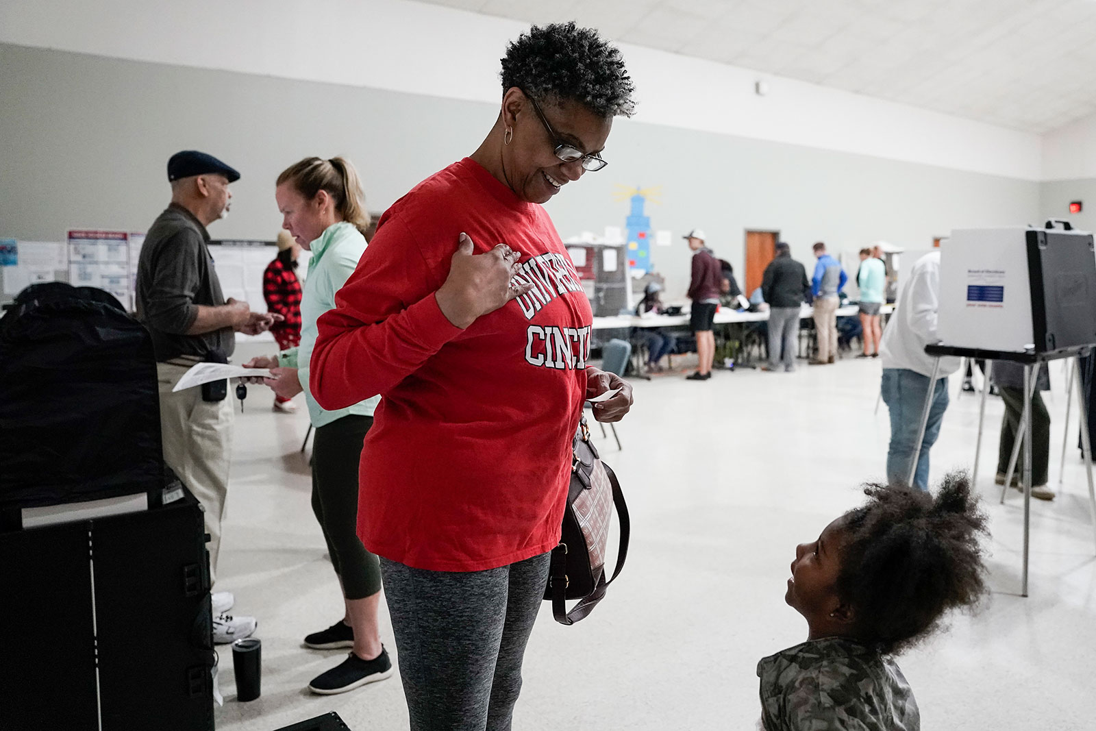 Yvette Murray places a sticker on her shirt after submitting her ballot Tuesday in Cincinnati.