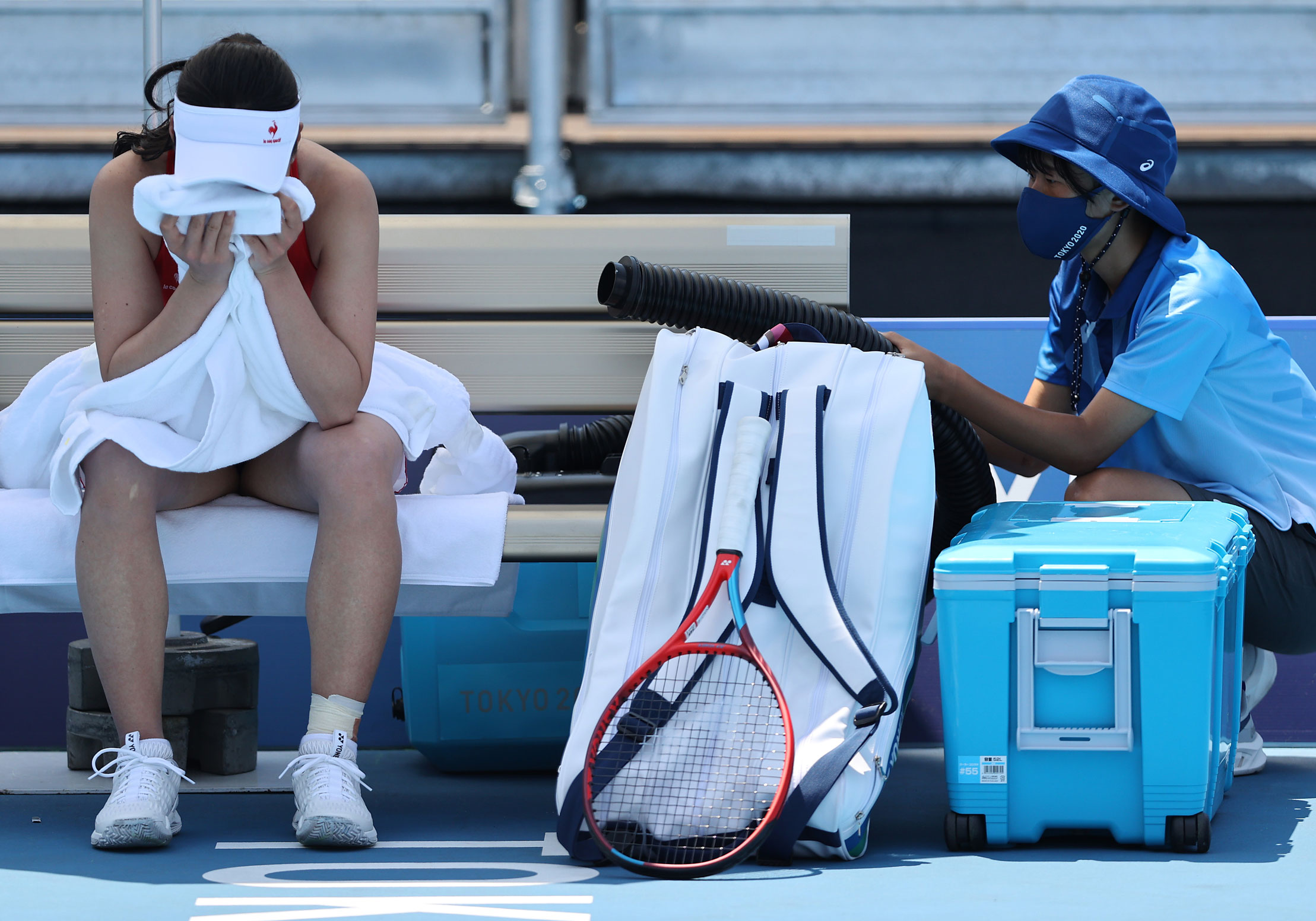 Nao Hibino of Japan cools down between games during her Women's Singles First Round match on July 24.