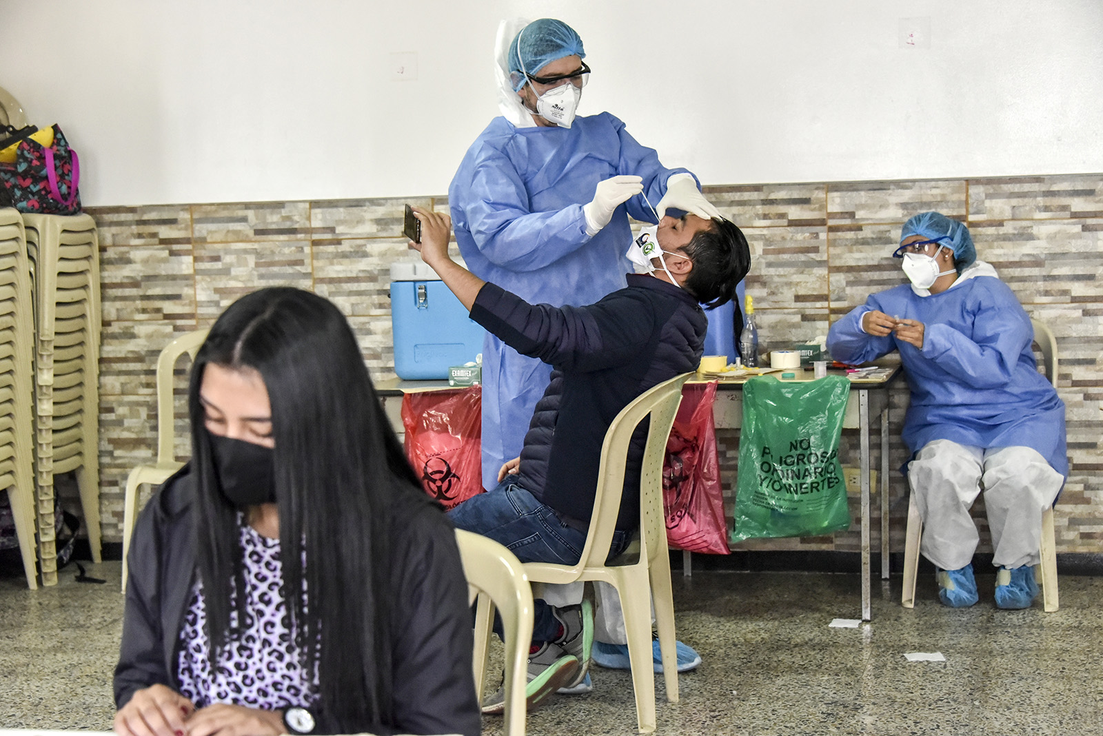 A medical worker takes a swab sample from a person to test for the novel coronavirus (COVID-19) on July 29, in Bogota, Colombia.