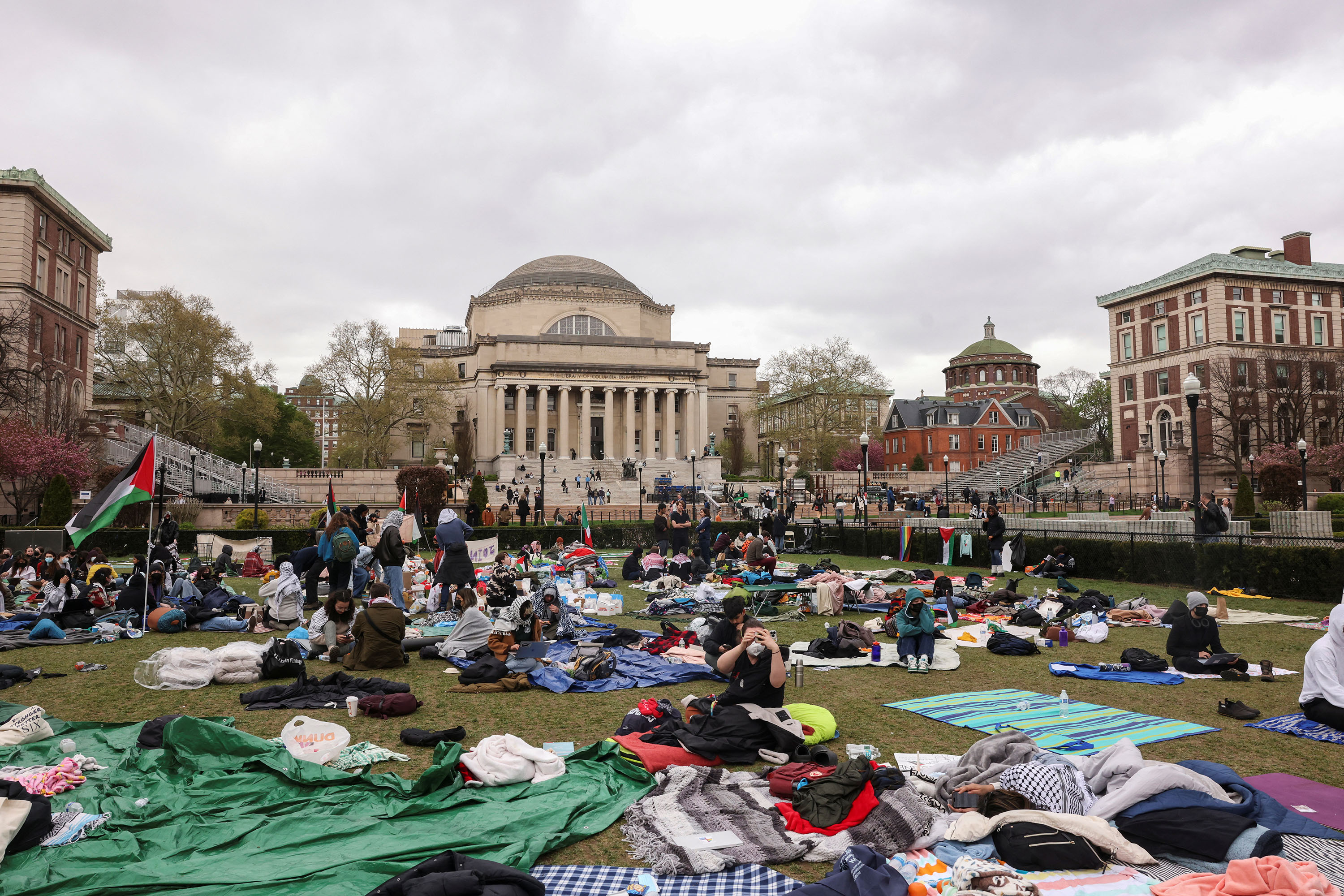 Demonstrators sit in an encampment as they protest in solidarity with Pro-Palestinian organizers on the Columbia University campus in New York City, on April 19. 