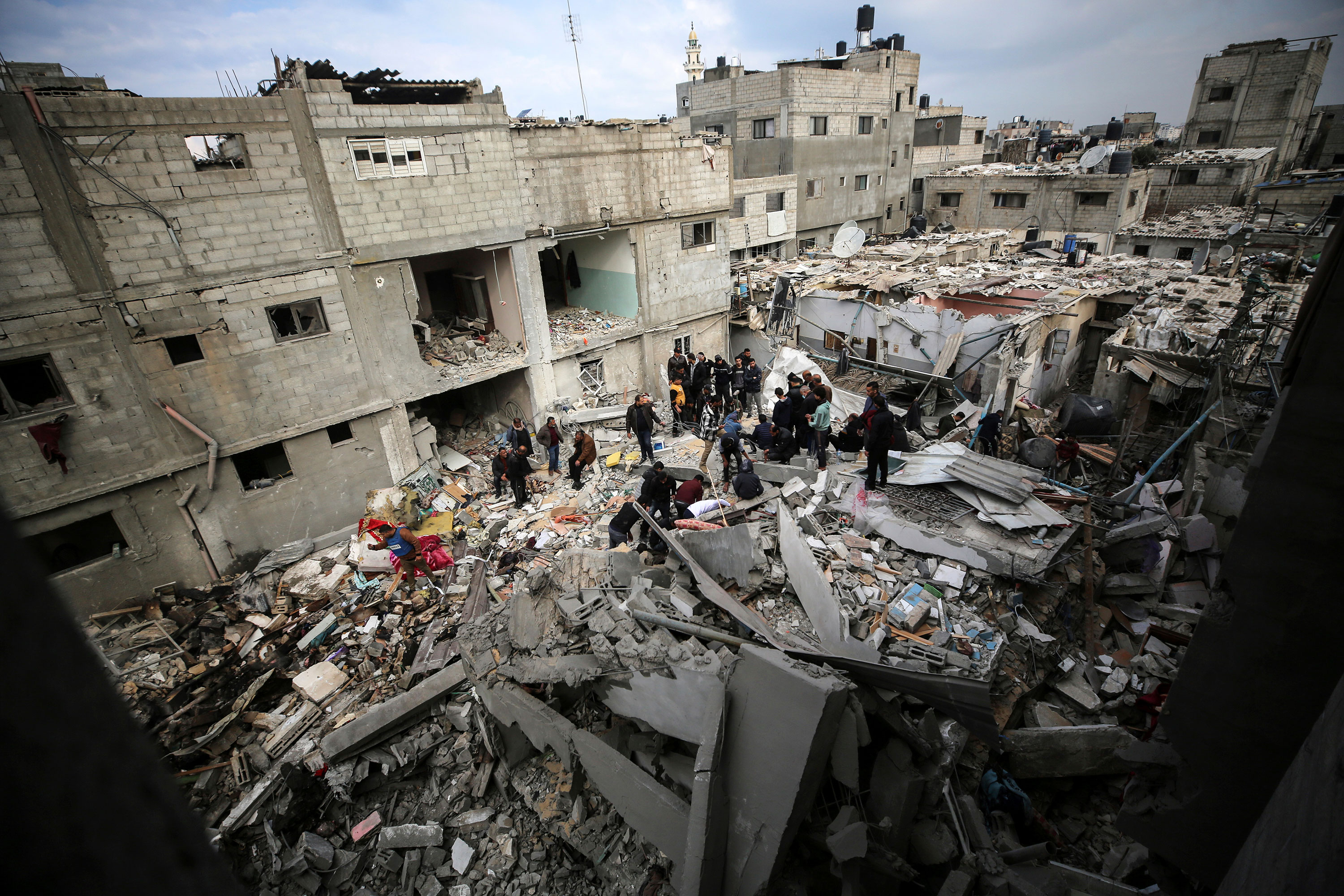 Palestinians inspect damage following an Israeli strike in Nuseirat, Gaza, on January 25.