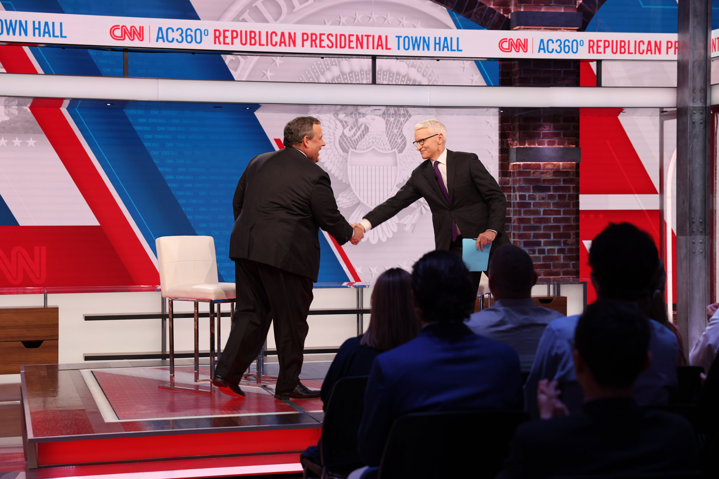 Former New Jersey Governor shakes hands with CNN's Anderson Cooper at the start of a CNN Republican Presidential Town Hall in New York on Monday, June 12.