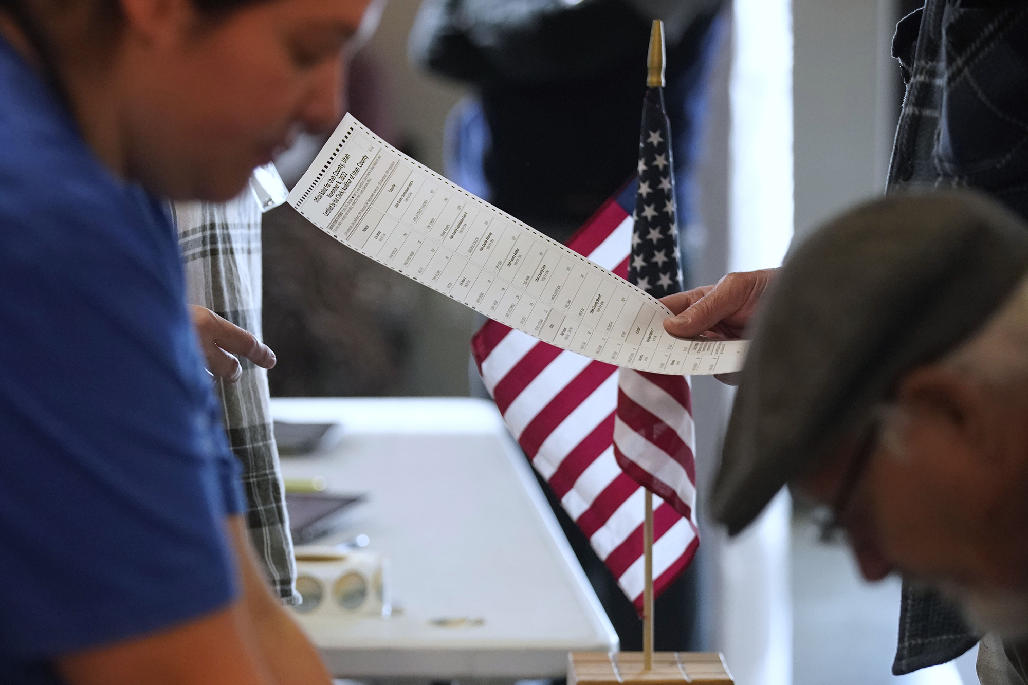 A voter looks over his ballot before voting at the Center Point Church in Orem, Utah, on Tuesday.