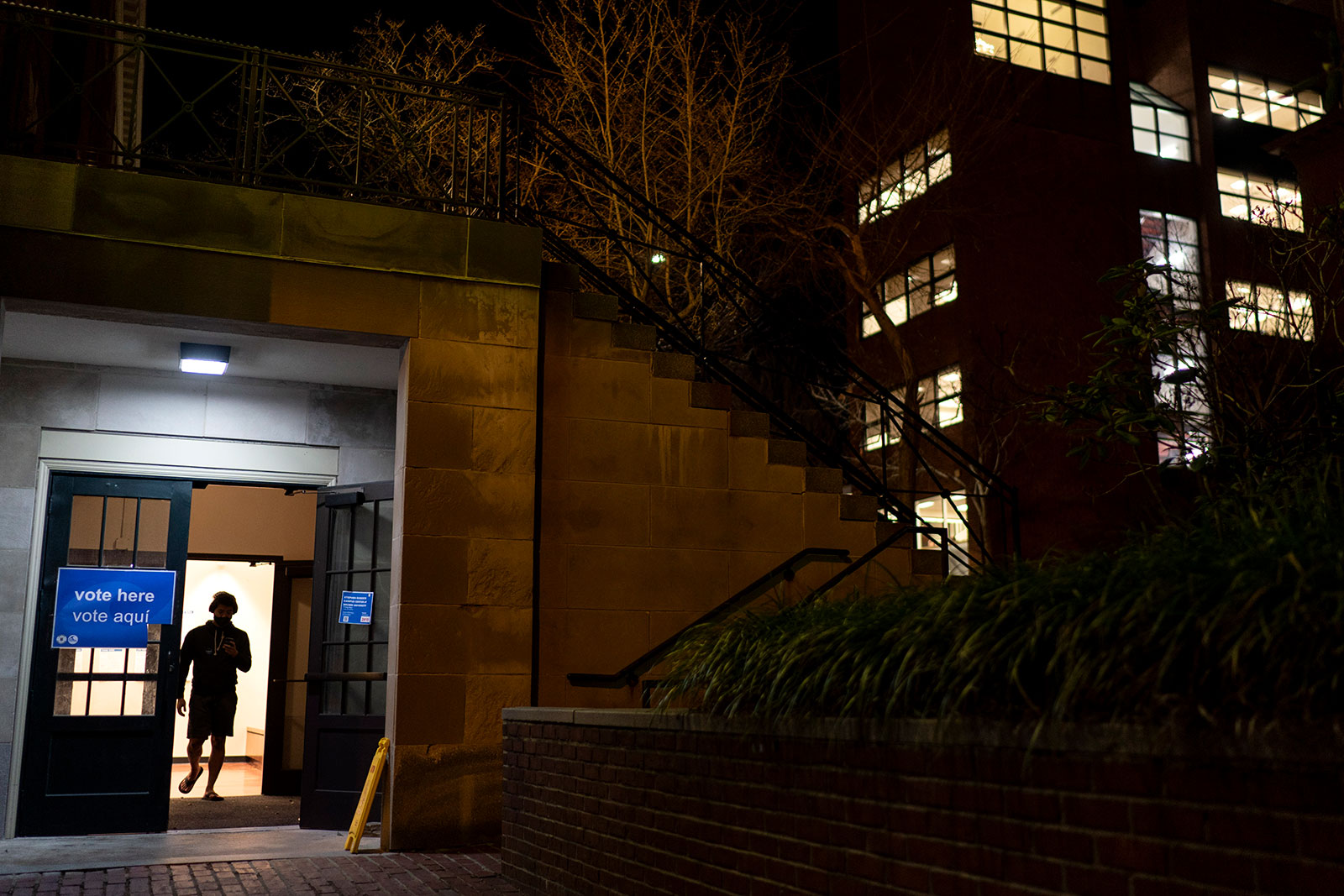 A person walks out of a polling site at Brown University hours before the polls close in Providence, Rhode Island, on Tuesday. 
