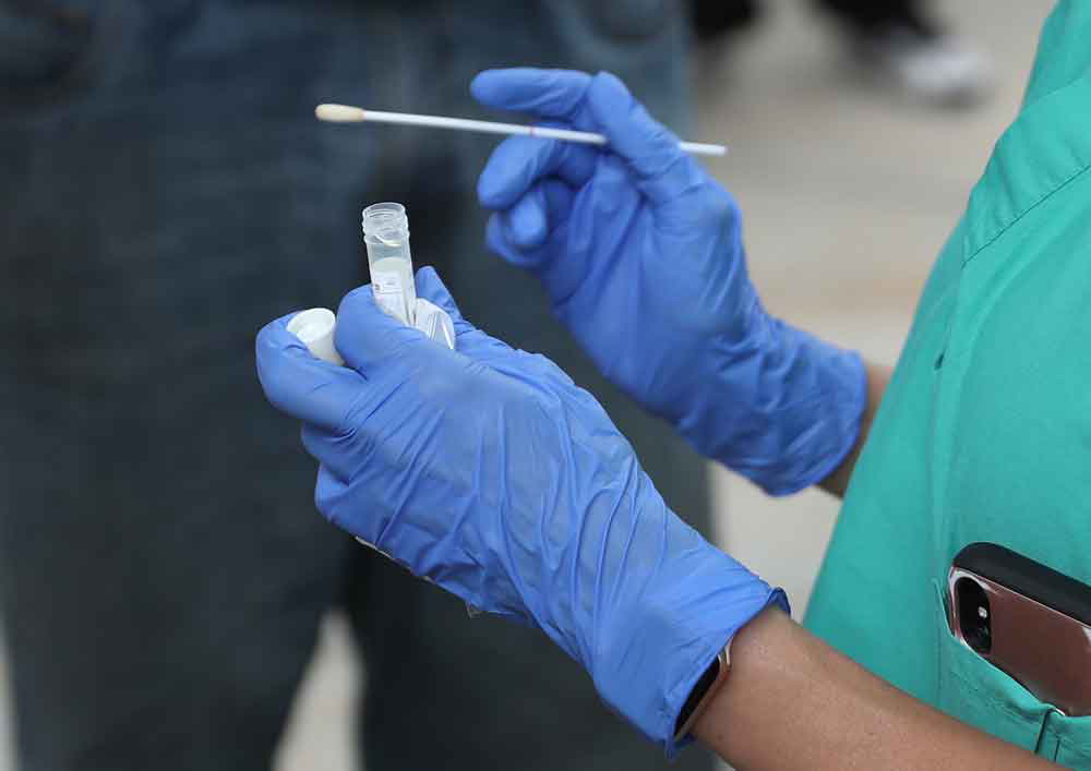 Dr. Natalia Echeverri, prepares a swab to gather a sample from the nose of a homeless person to test for Covid-19 on April 17, in Miami, Florida.