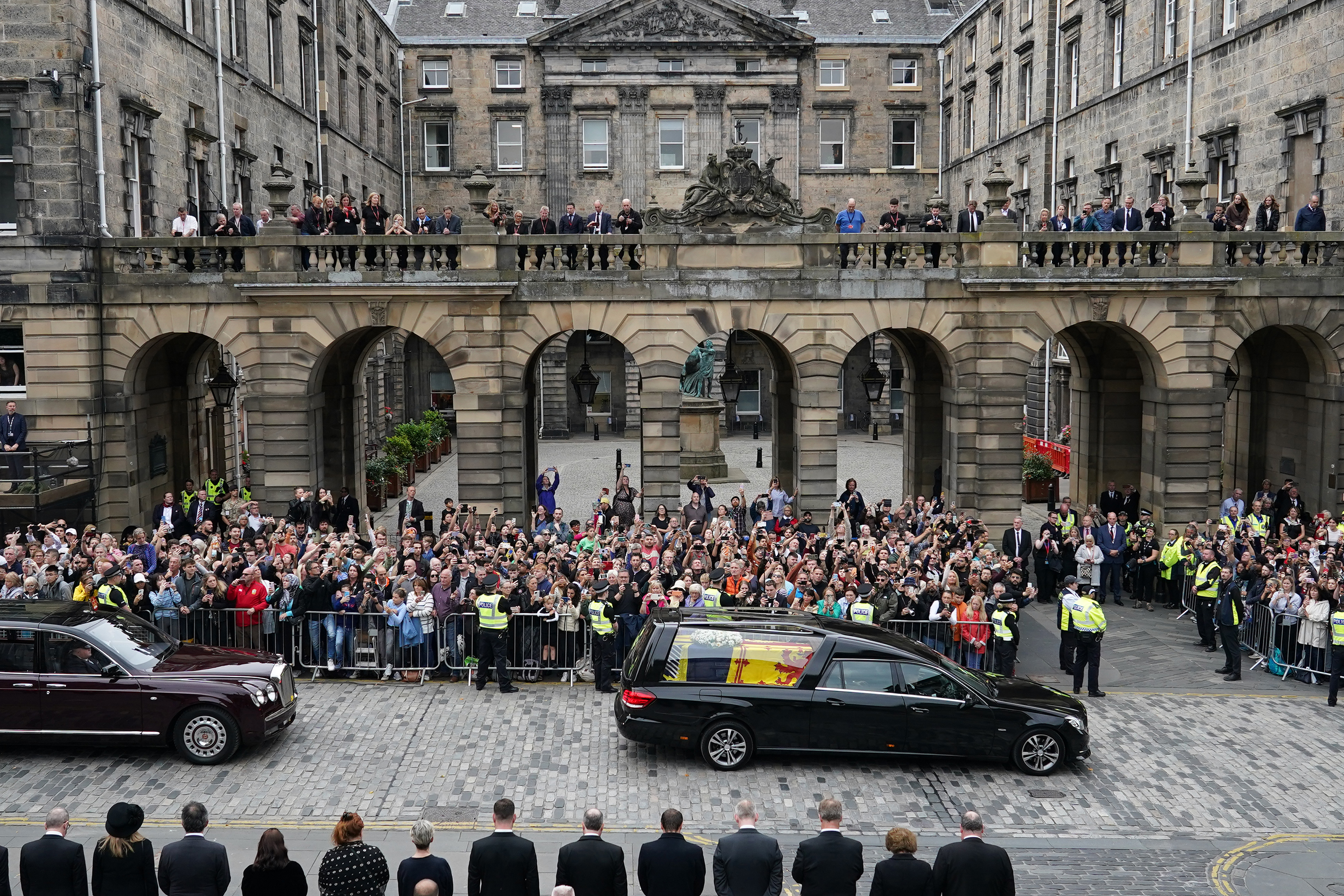Crowds watch the royal cortege in Edinburgh.